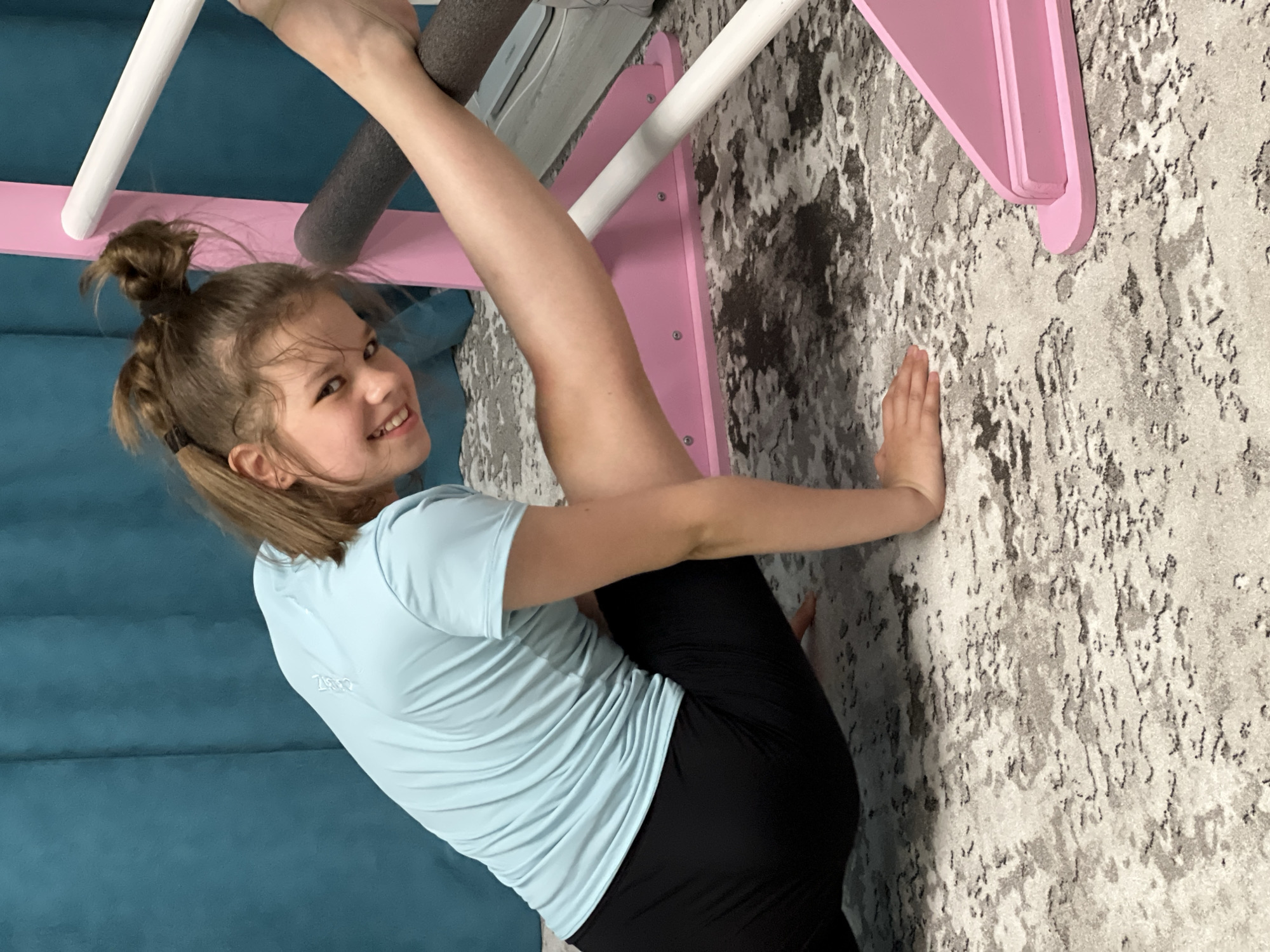 Girl practices gymnastics routines indoors in Chaikovsky, Russia