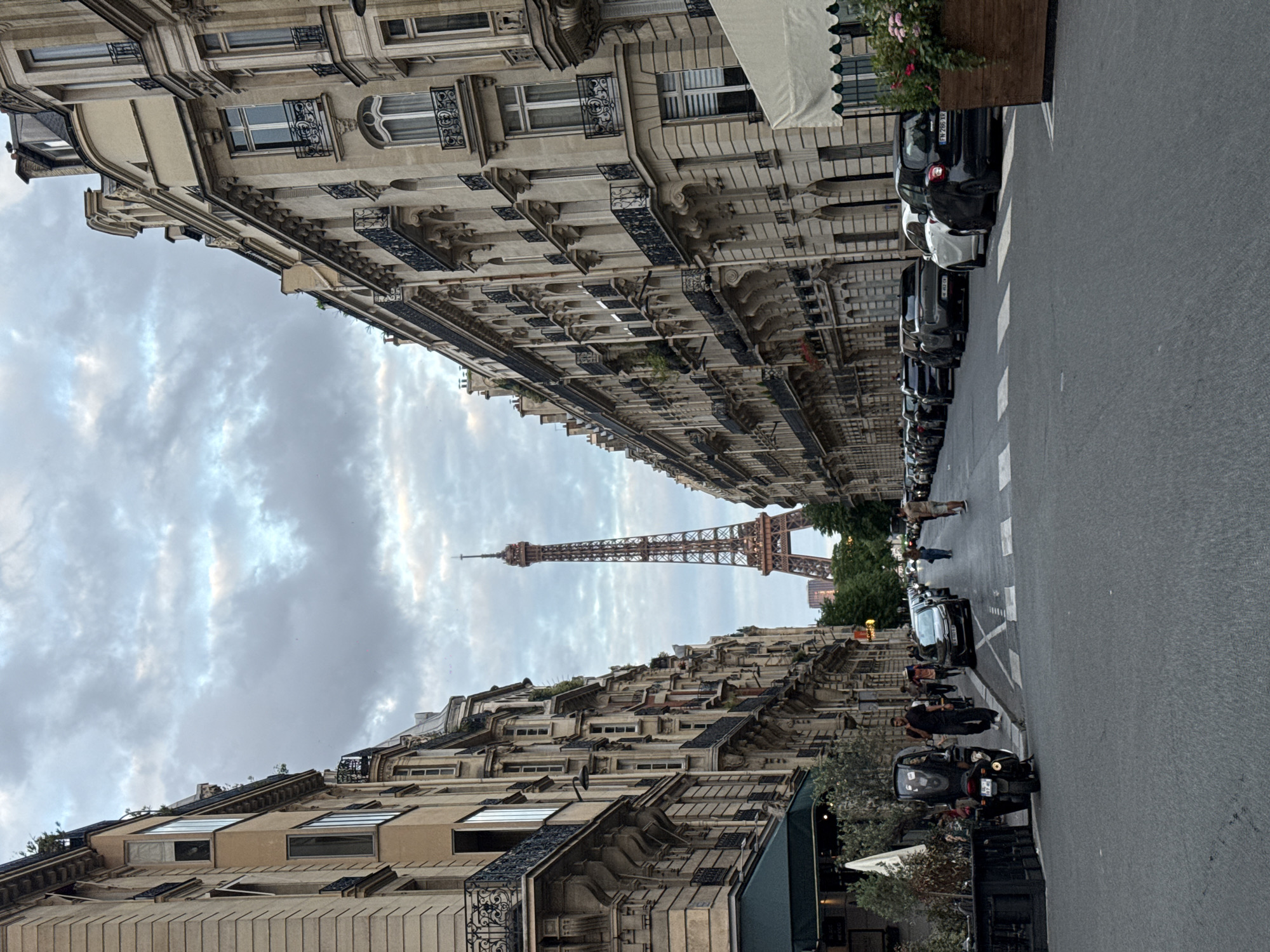 Parisian street view with Eiffel Tower captured Sunday evening