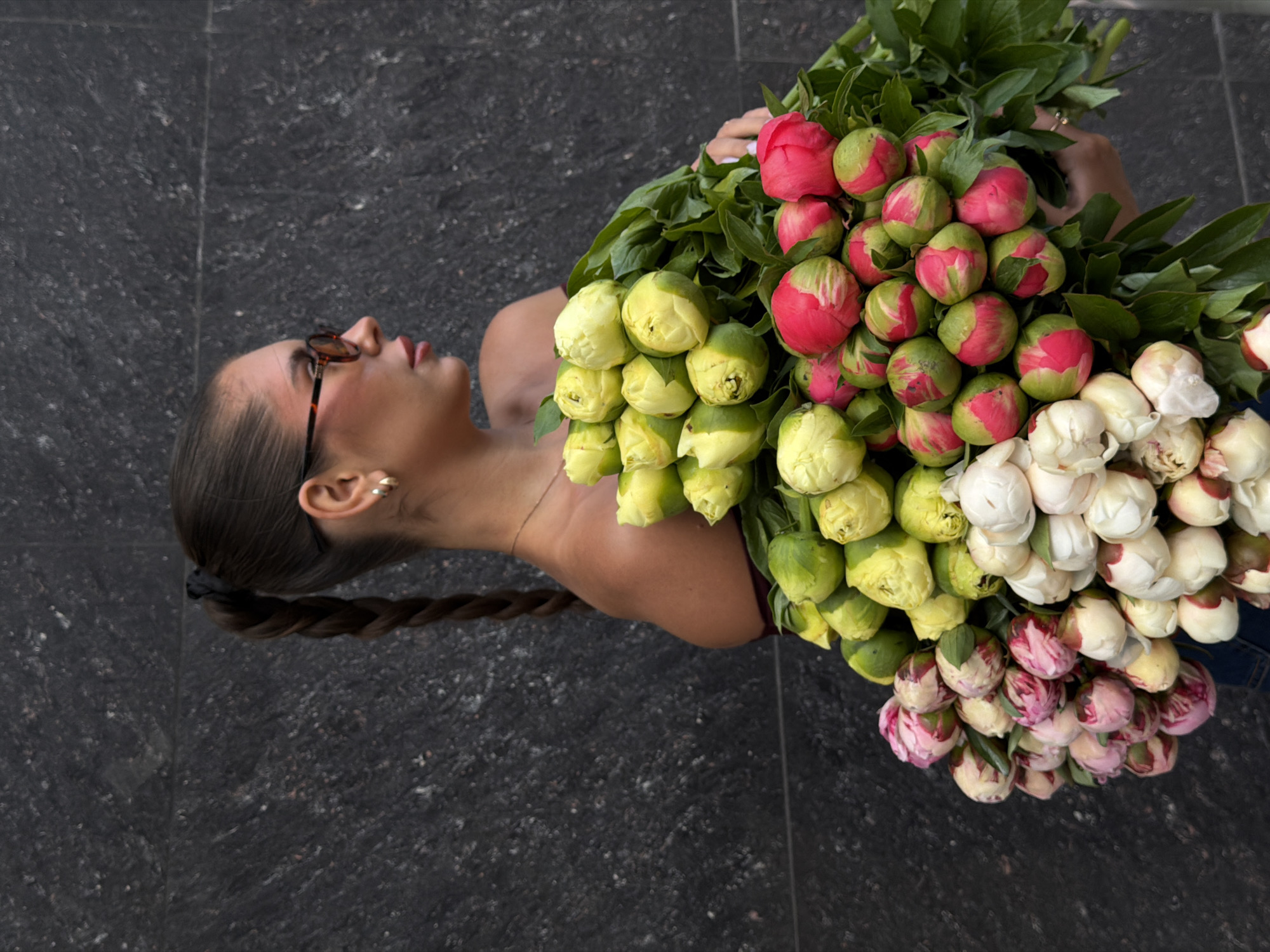 Woman holds colorful peony bouquet in Krasnoyarsk