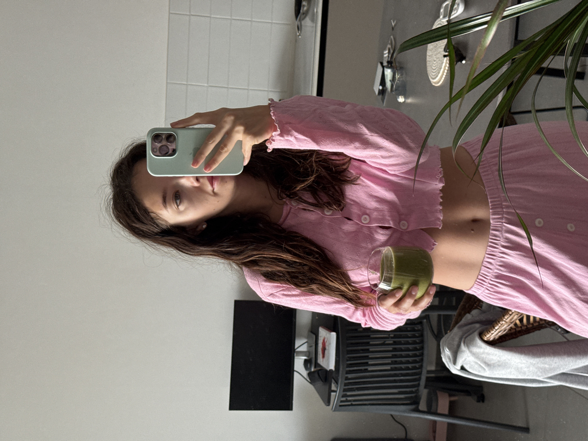 Woman takes mirror selfie with smoothie in Tel Aviv