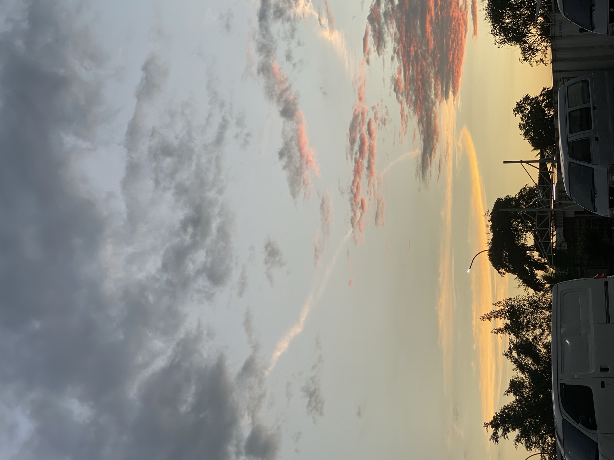 Dusk settles over a busy parking lot in Gambut Barat