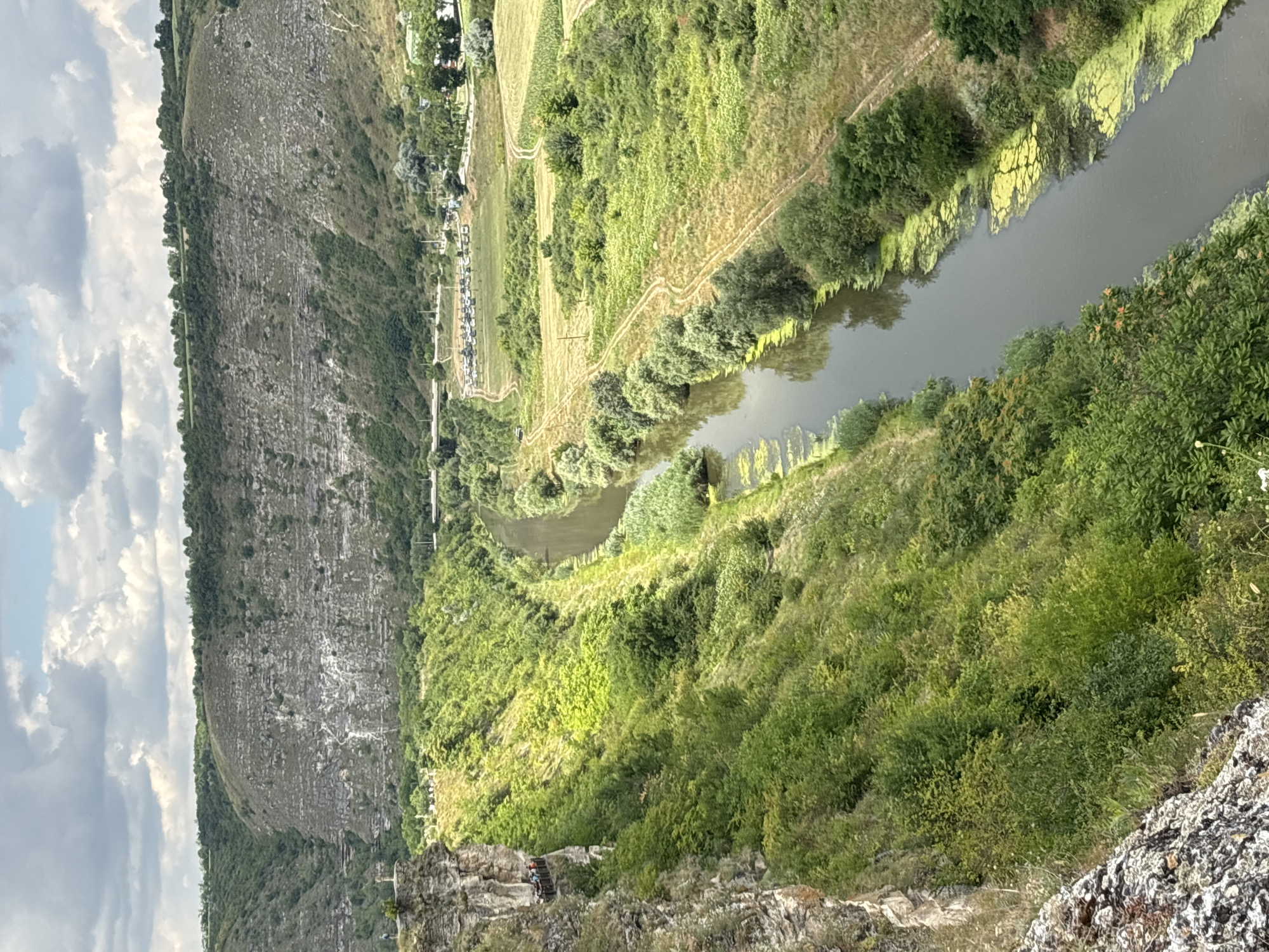 Wooden cliff platform overlooks a winding river valley in Moldova