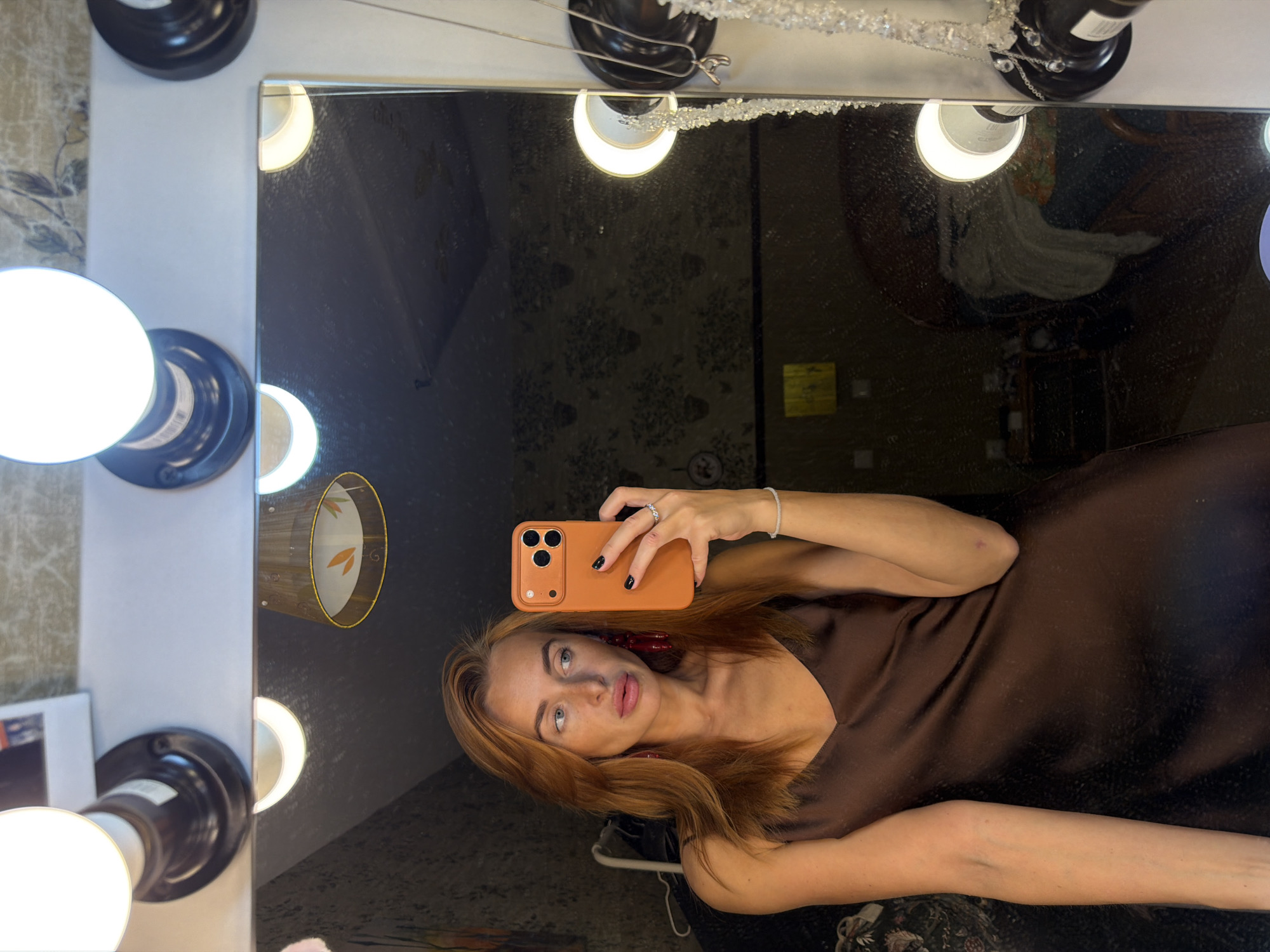 Woman takes vanity mirror selfie in Krasnoyarsk room