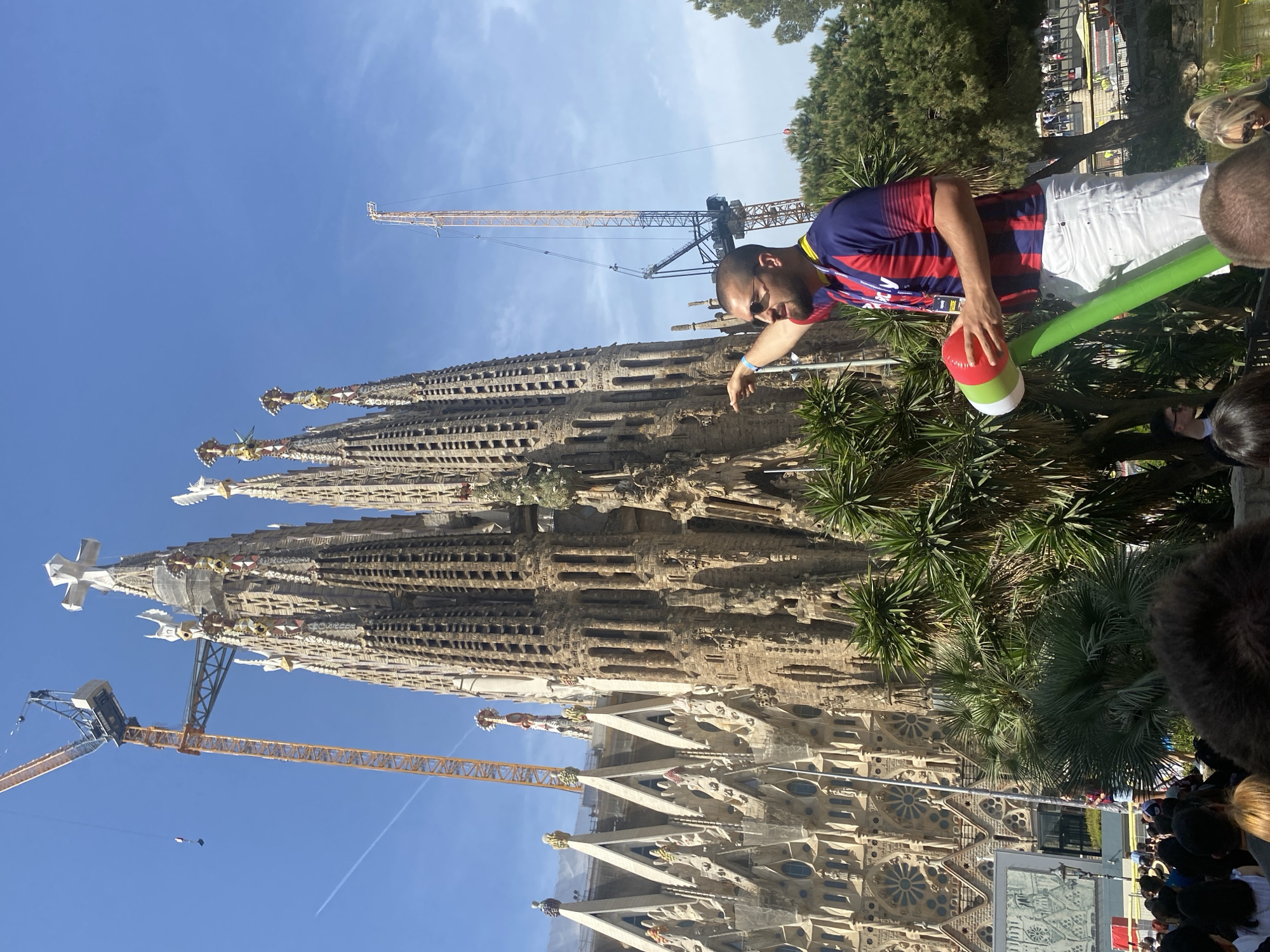 Tourist observes Sagrada Familia on sunny Barcelona morning