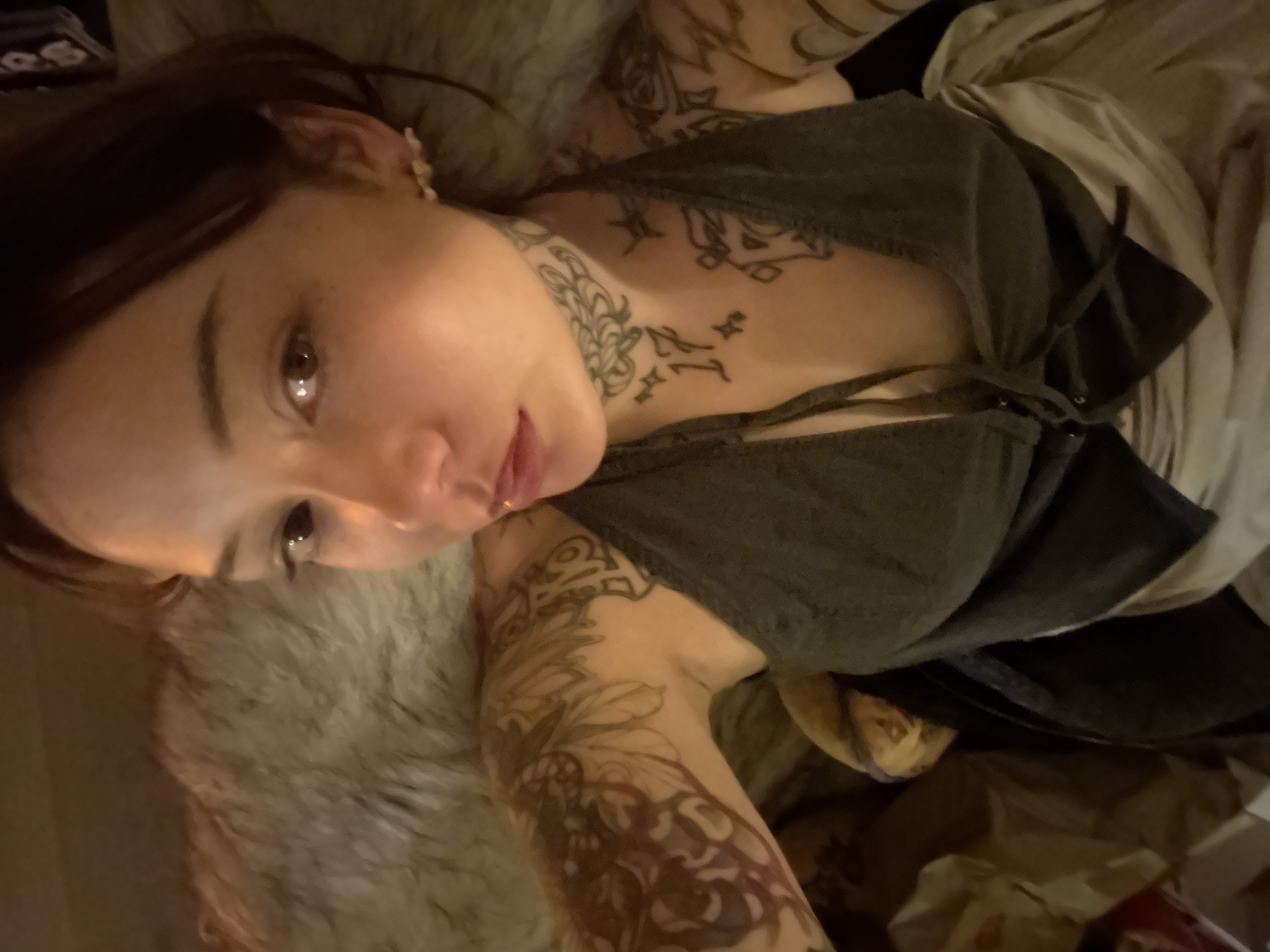 Person resting on bed photographed in London early morning