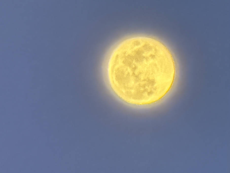 Bright yellow moon with visible craters observed in Krasnoyarsk