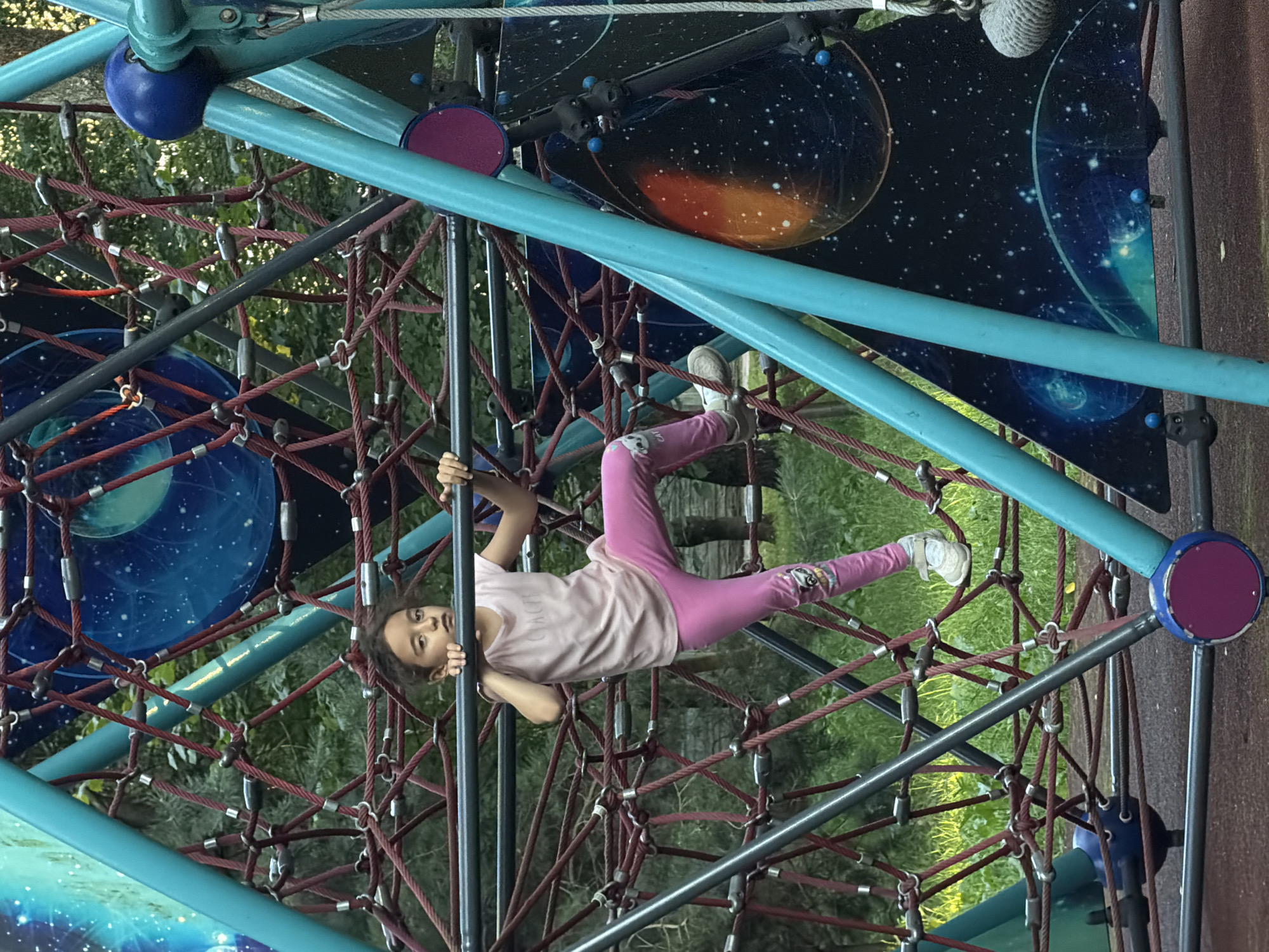 Kids climbing and skating on a playground structure.