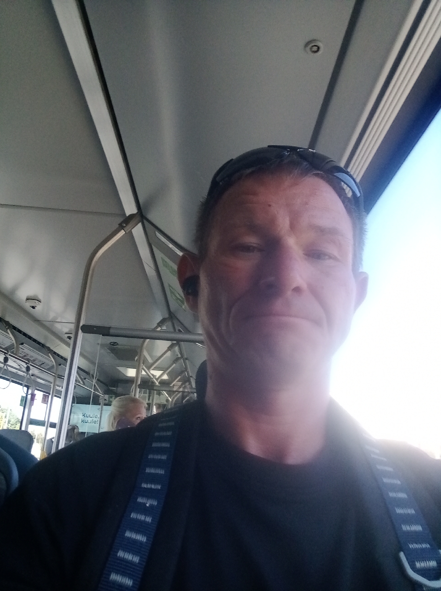 Quick selfie pair: transit interior then street-level stop