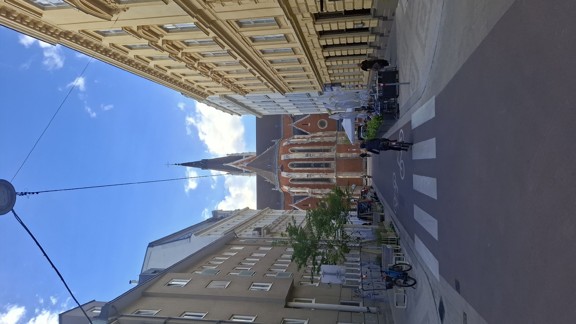 Vienna street scenes captured near Votivkirche with cyclists, pedestrians