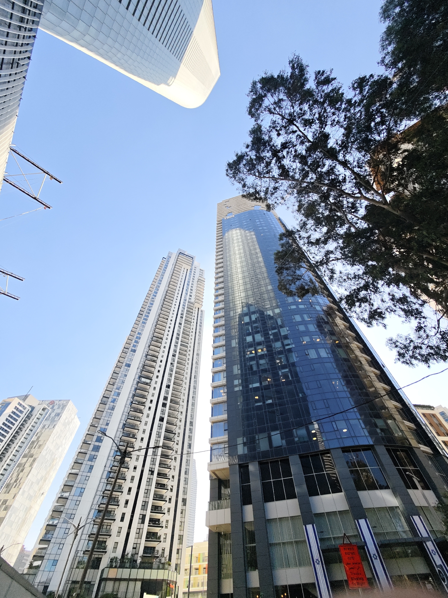 Tel Aviv–Givatayim skyline walk with plumeria close-ups
