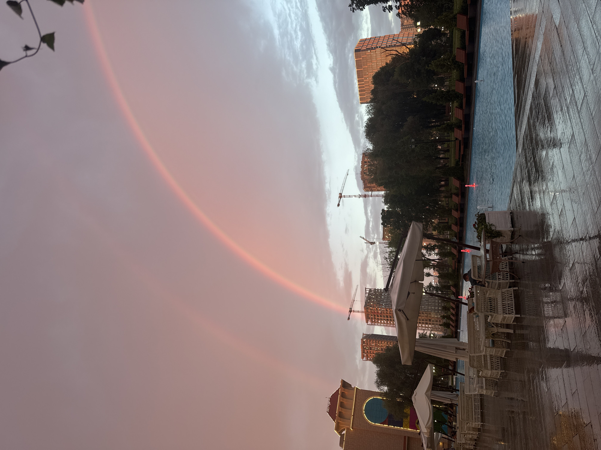 Rainbows over a Moscow pool deck after an evening storm