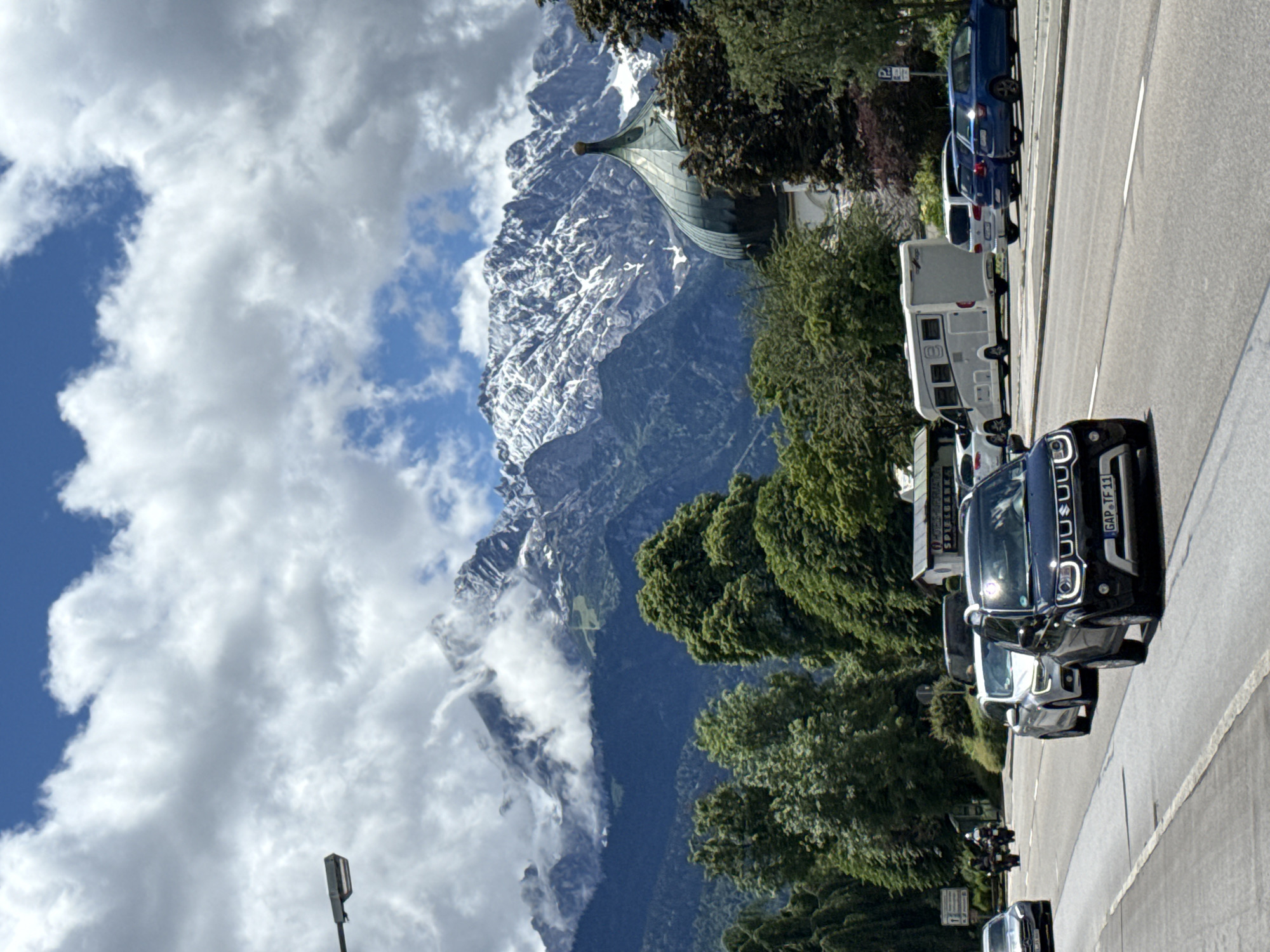 Traffic flows through scenic Garmisch-Partenkirchen beneath Alpine peaks
