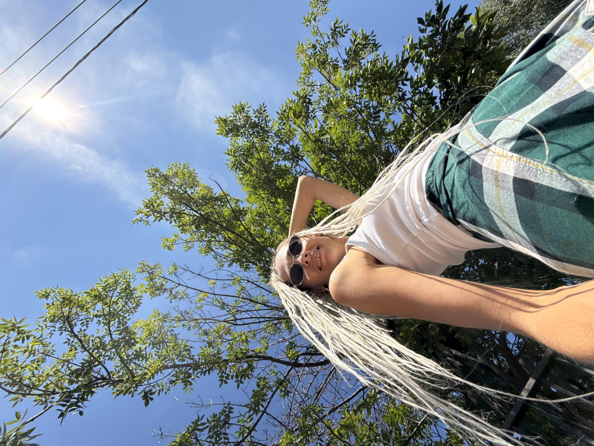 Sunny summer portraits among green trees in Rusanovo