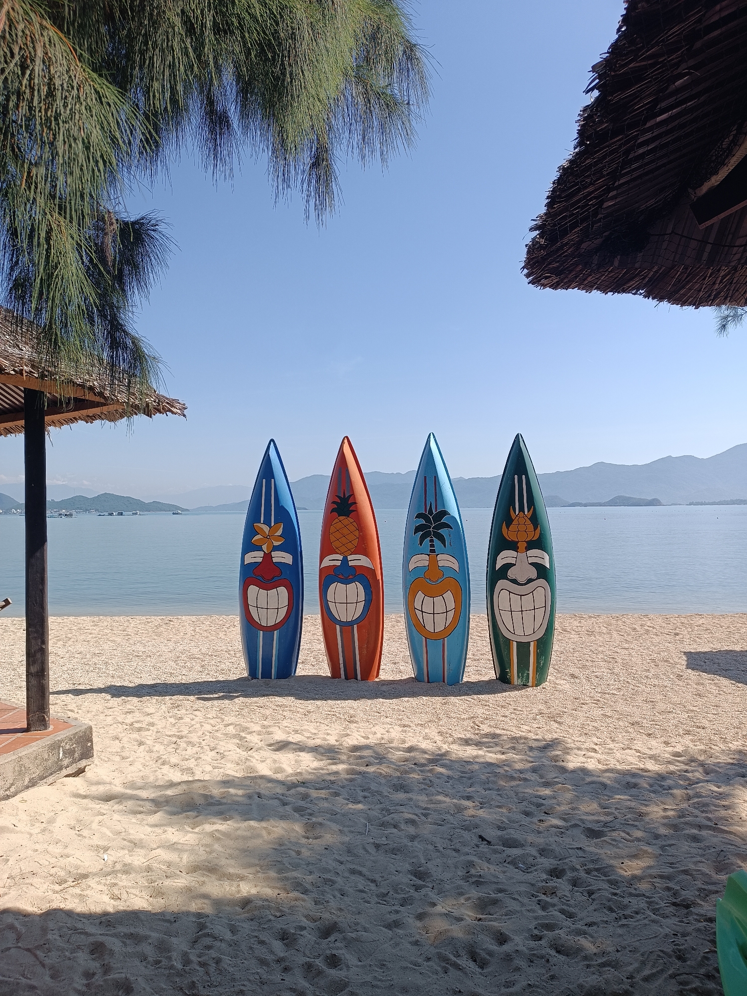 Tiki boards, painted rocks, and garden paths at a Nha Trang beach spot