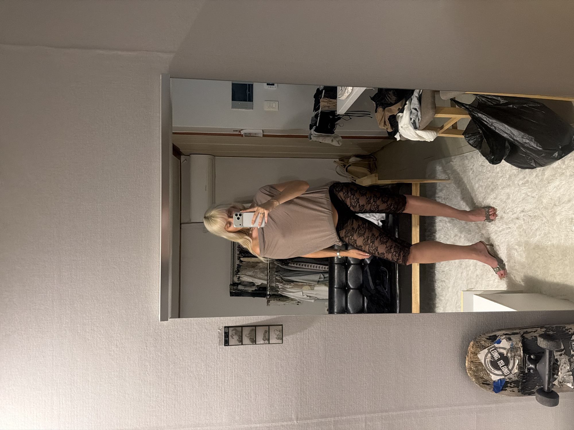 Woman takes mirror selfie in Seoul room