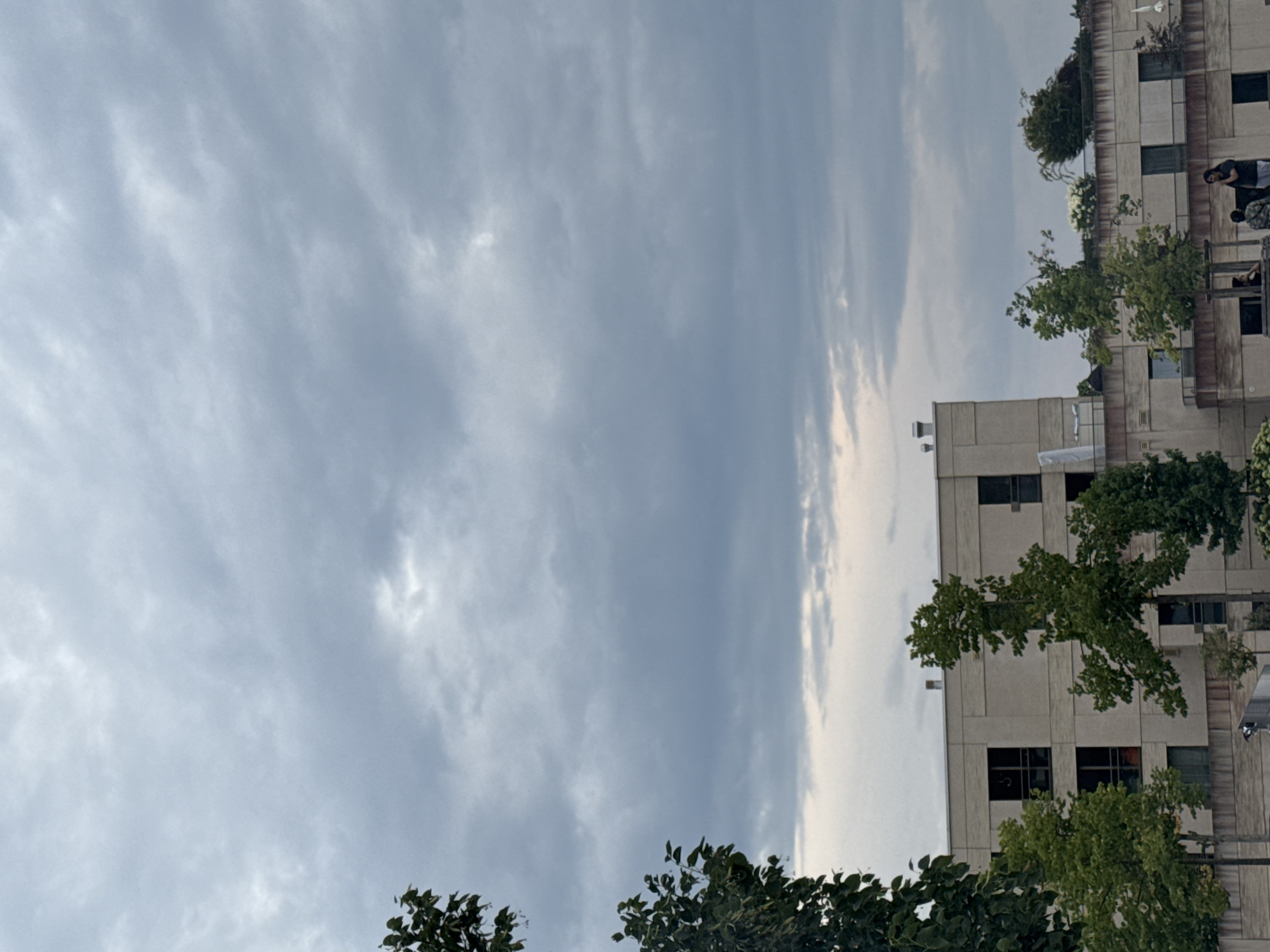 Buildings and power infrastructure under an overcast sky