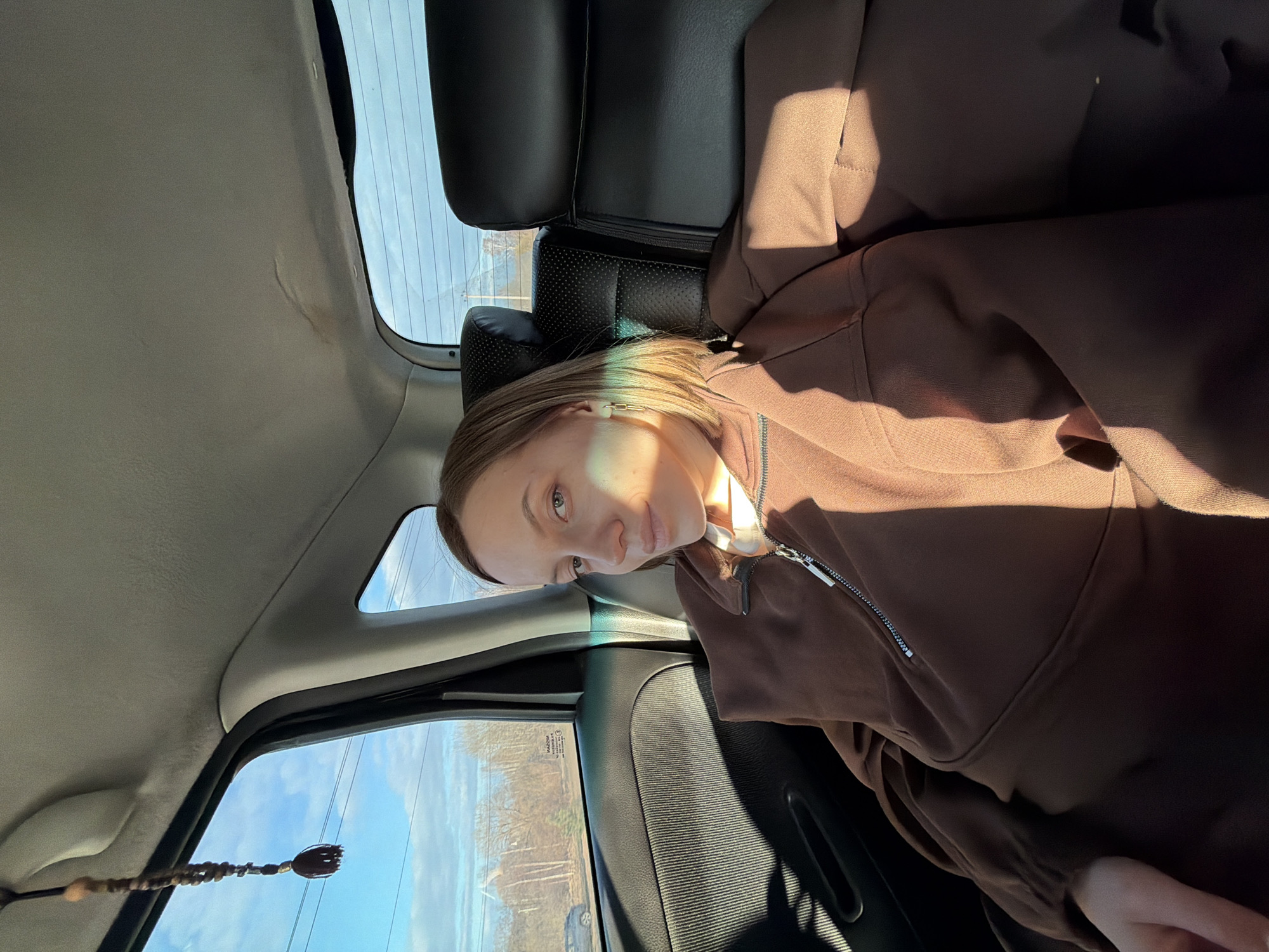 Person photographed in car backseat in Minino, Russia