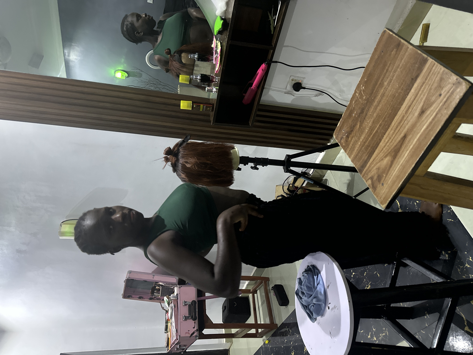 Wig styling and content creation setup in a Nigerian home studio