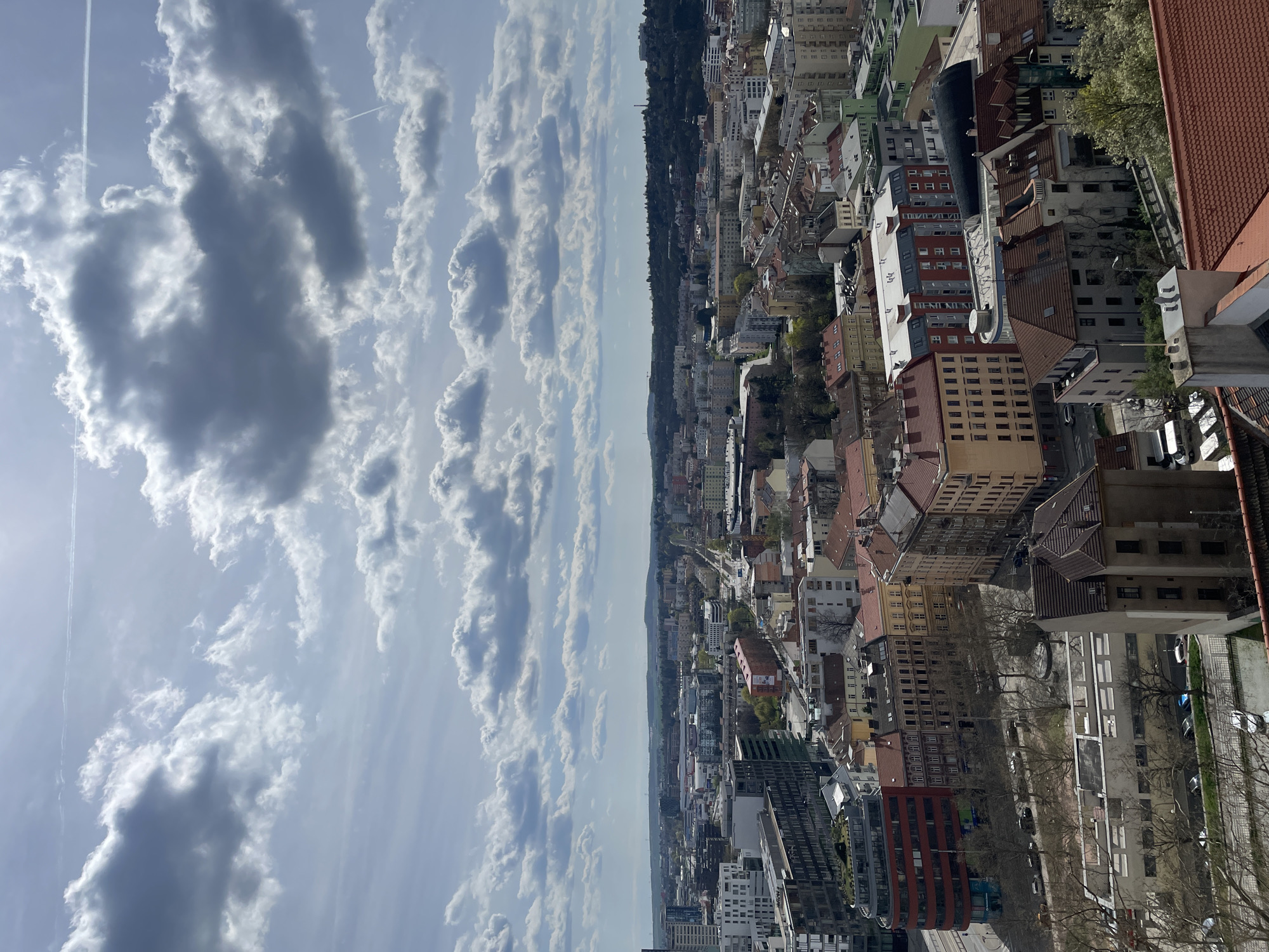Aerial view captures Brno cityscape under cloudy skies