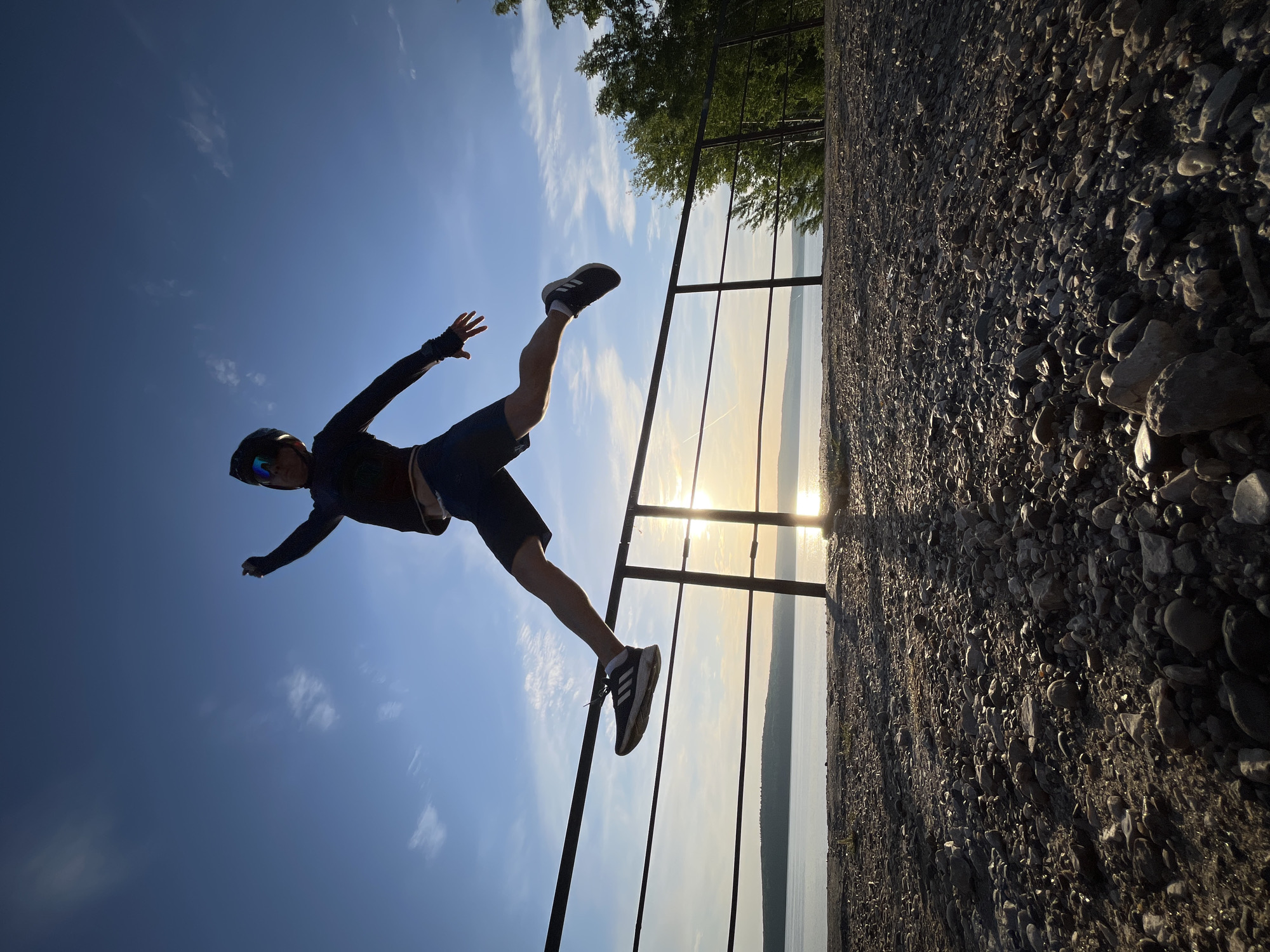 Cyclist performs lakefront stunts at sunset in Chaikovsky, Russia