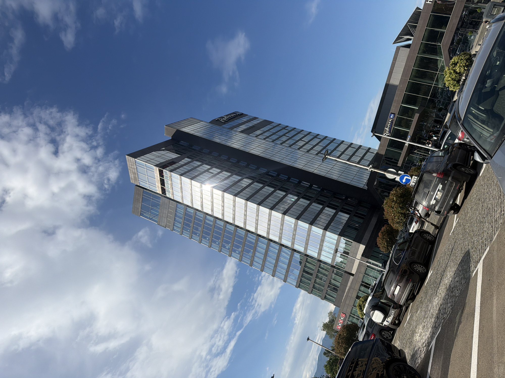 Urban street scene with Radisson hotel observed under clear skies