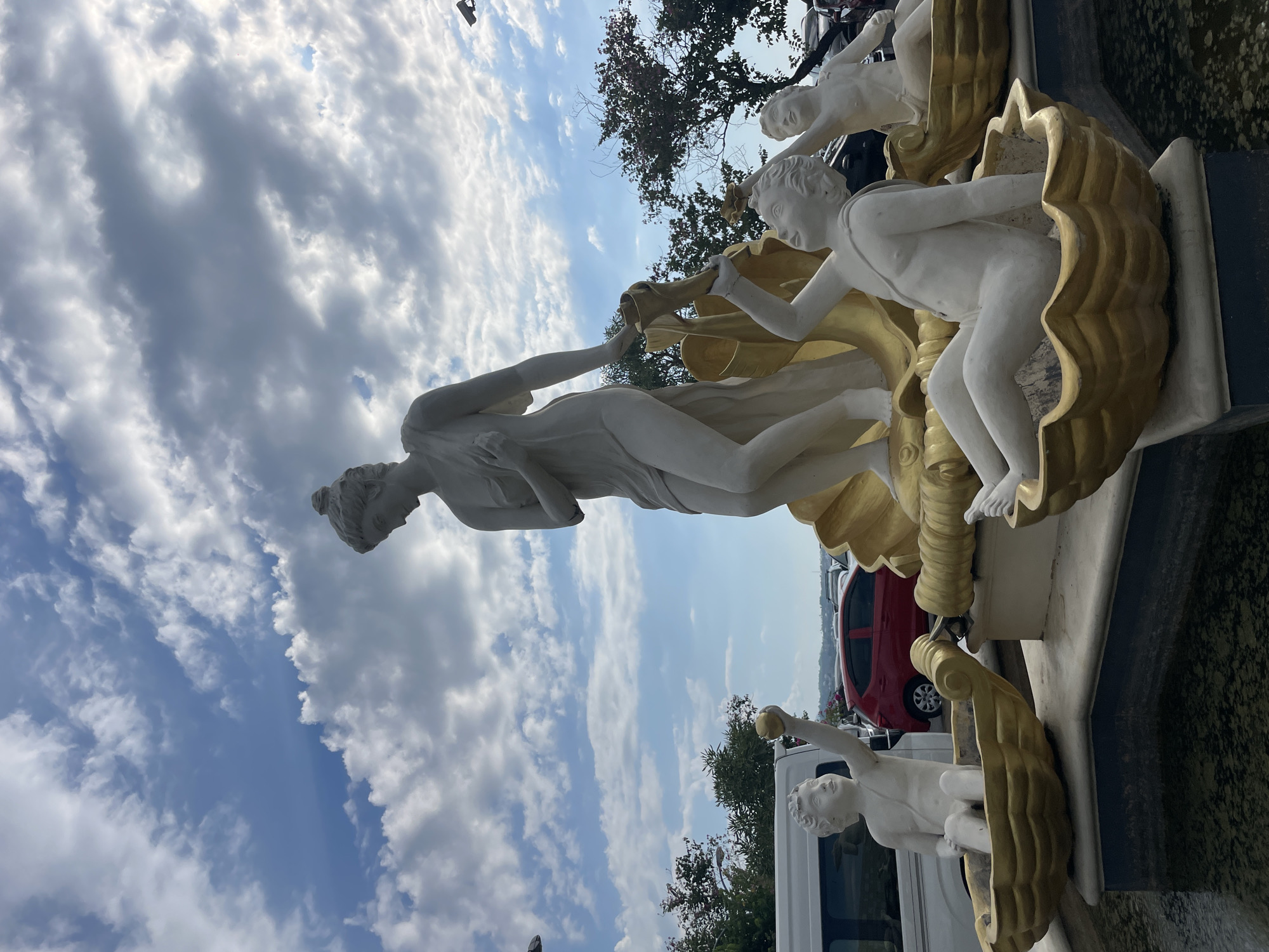 Manado's coastal promenade and shoreline sculpture on a clear morning