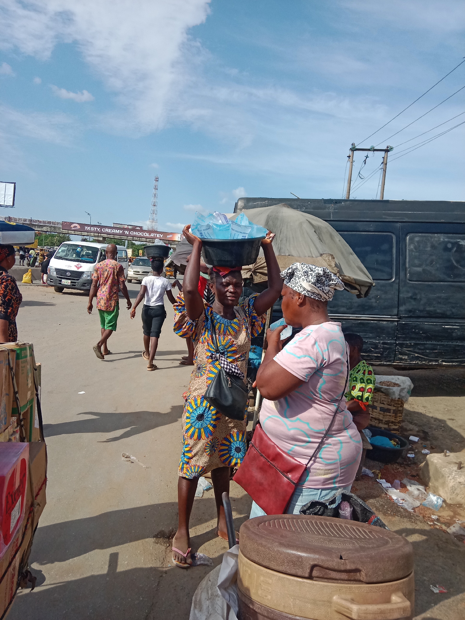 Street vendors sell water, sweets, household goods in Nigerian markets