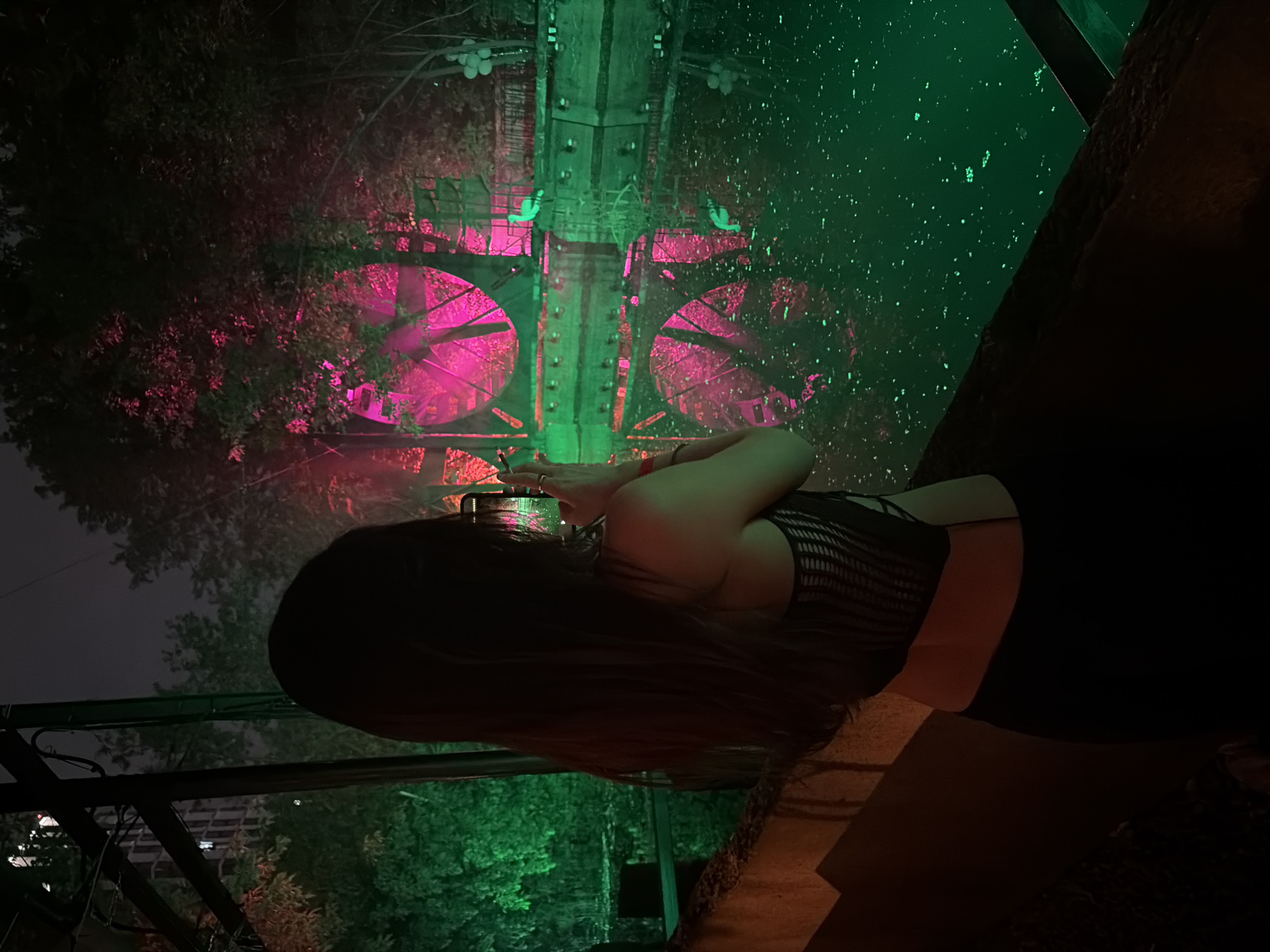 Woman photographs in darkened nightclub venue
