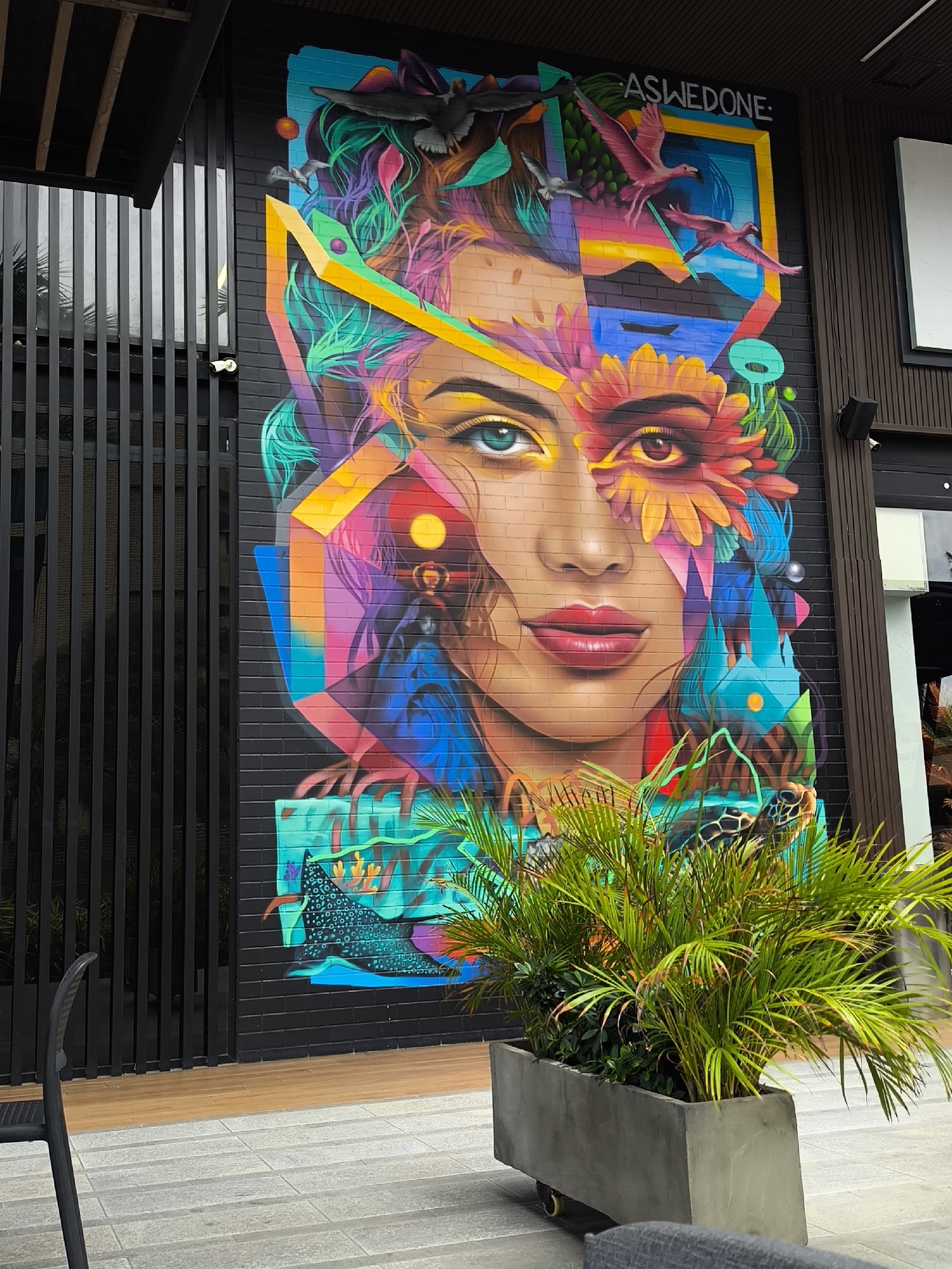 Outdoor dining area with mural documented in Pampatar, Venezuela