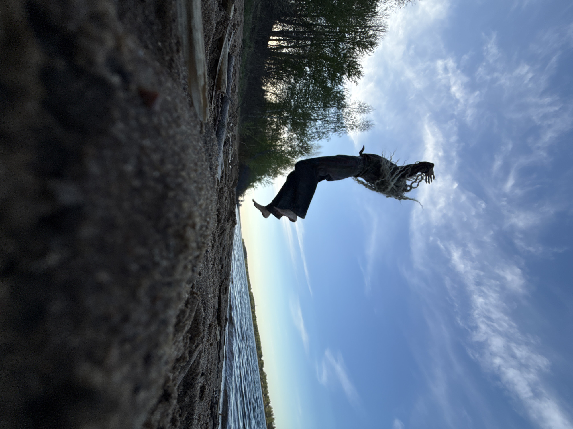 Person performs backflip on beach in Rusanovo, Russia