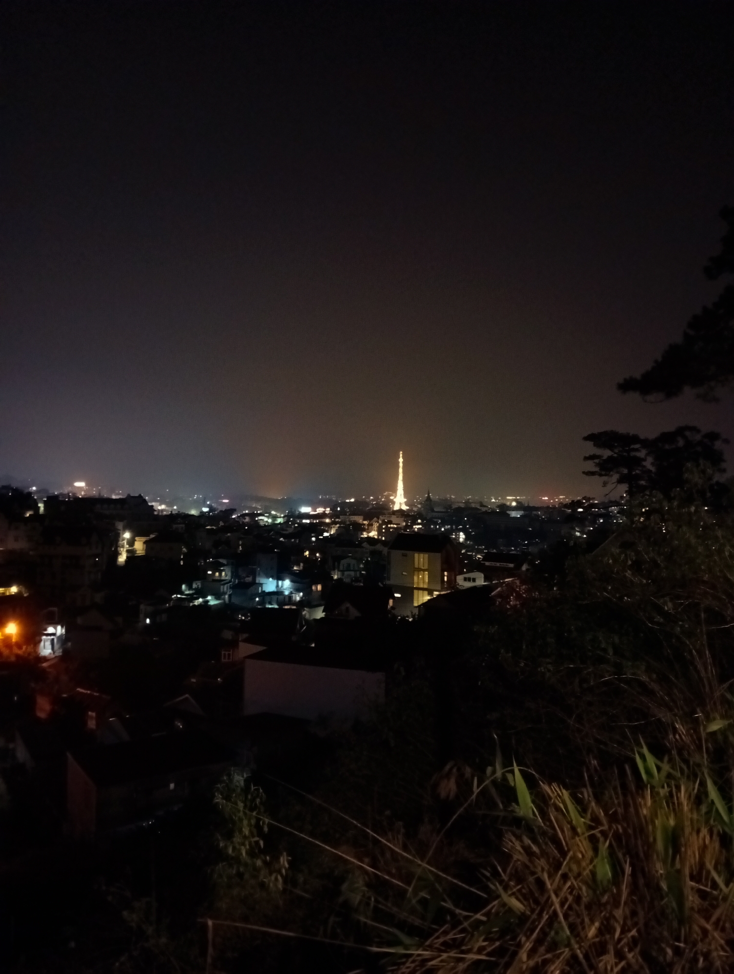 Da Lat's illuminated Eiffel Tower replica captured in nighttime cityscape