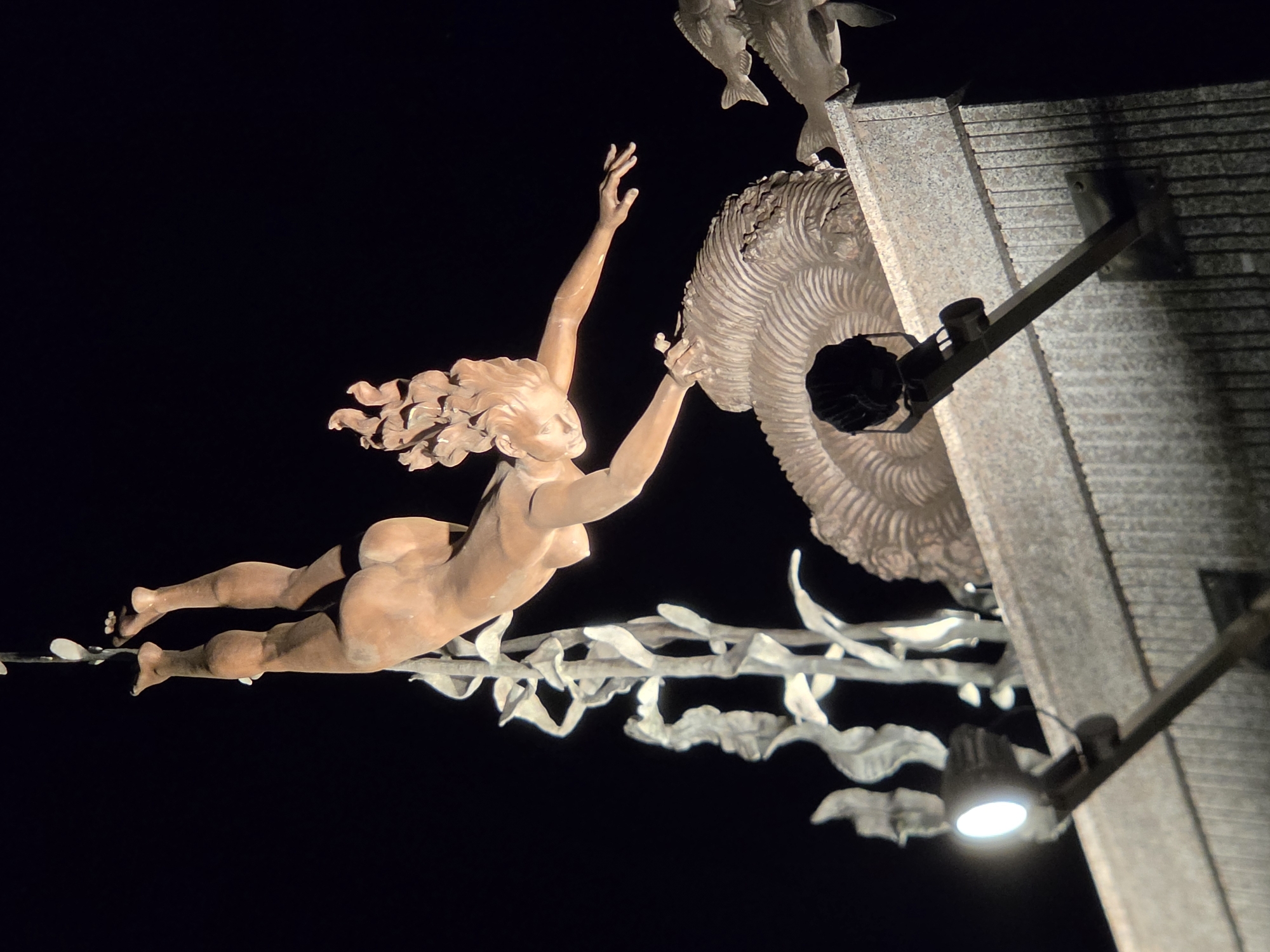 Tolyatti park at night: sculpture, salvia, and lamplit walkway
