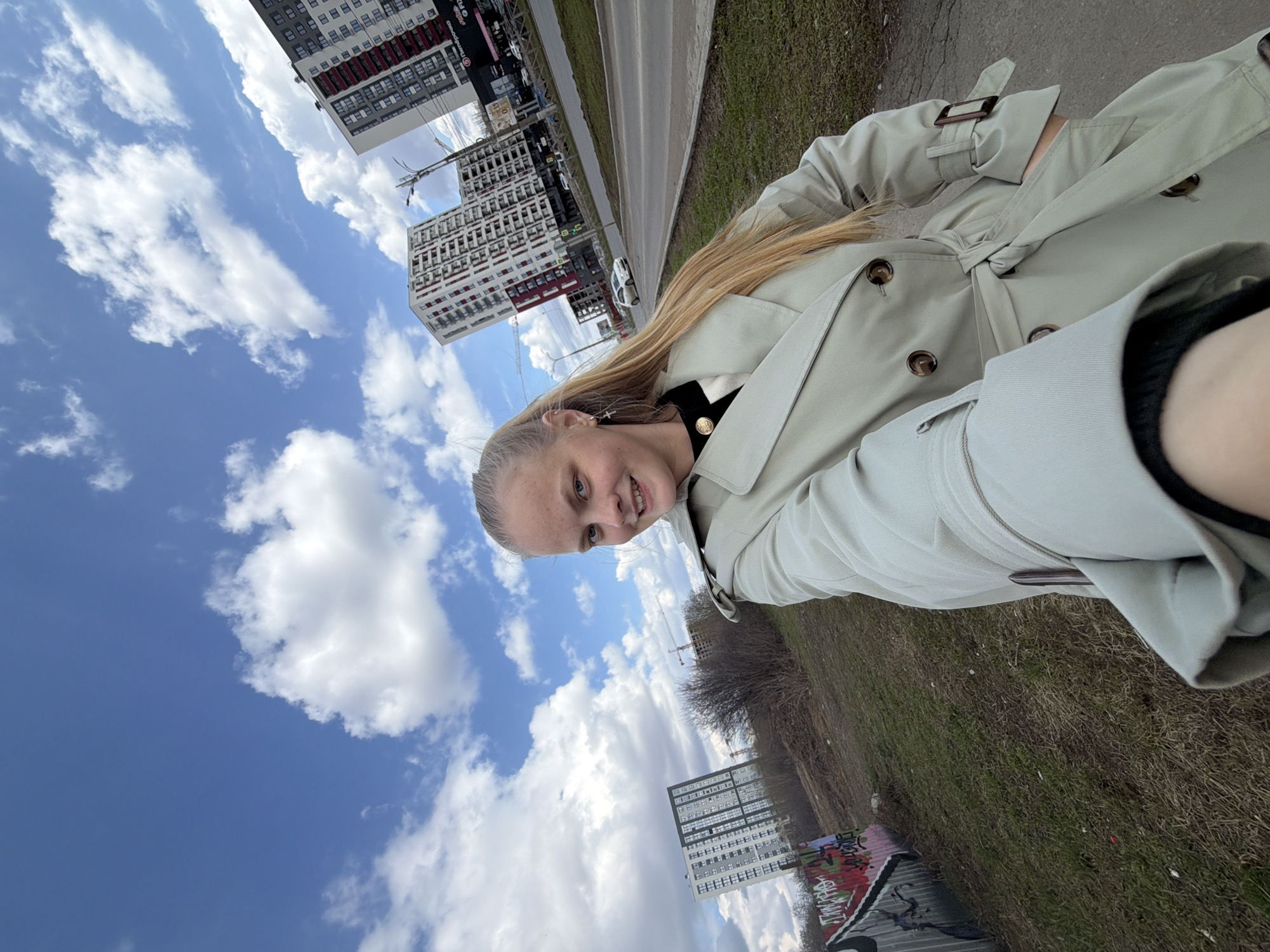 Woman in trench coat photographed in Izhevsk urban area