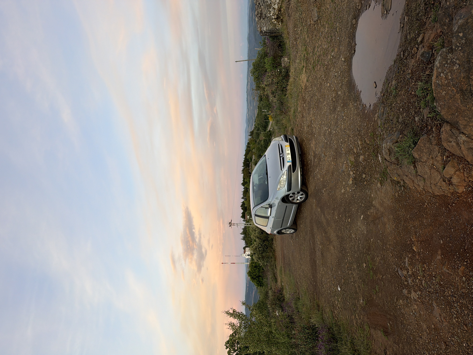 Silver Peugeot observed on dirt road during Bragança sunset