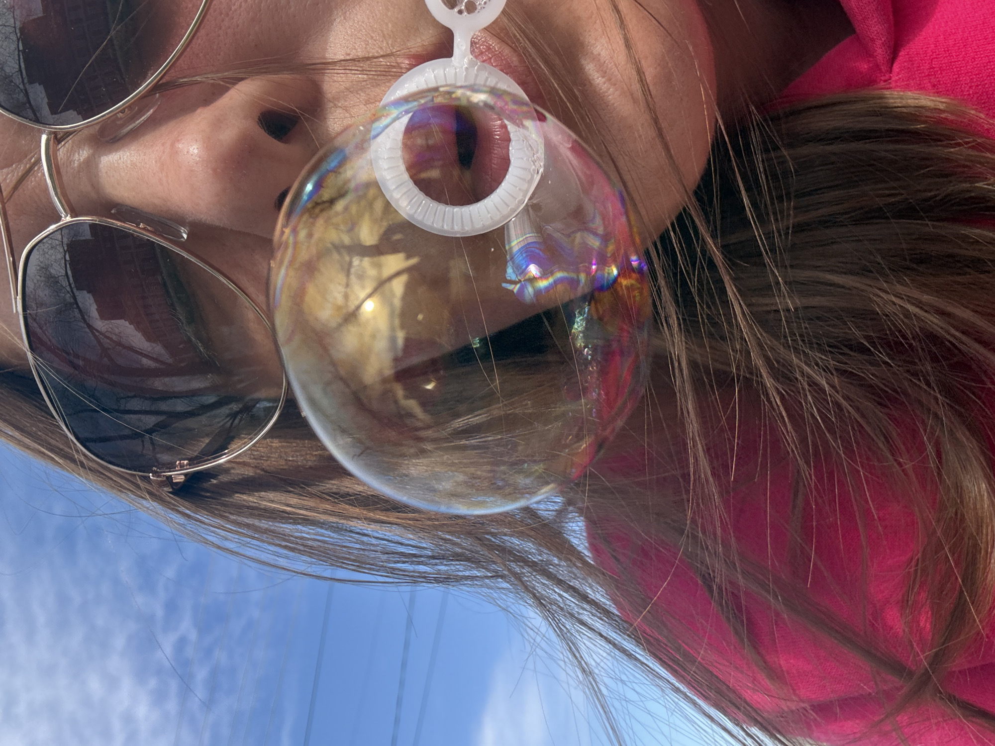 Person blows bubbles outdoors in Dmitrov, Russia morning scene