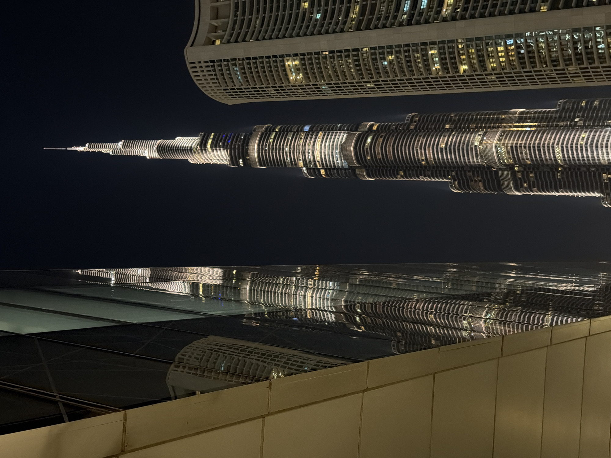 Burj Khalifa reflection captured in Dubai glass surface