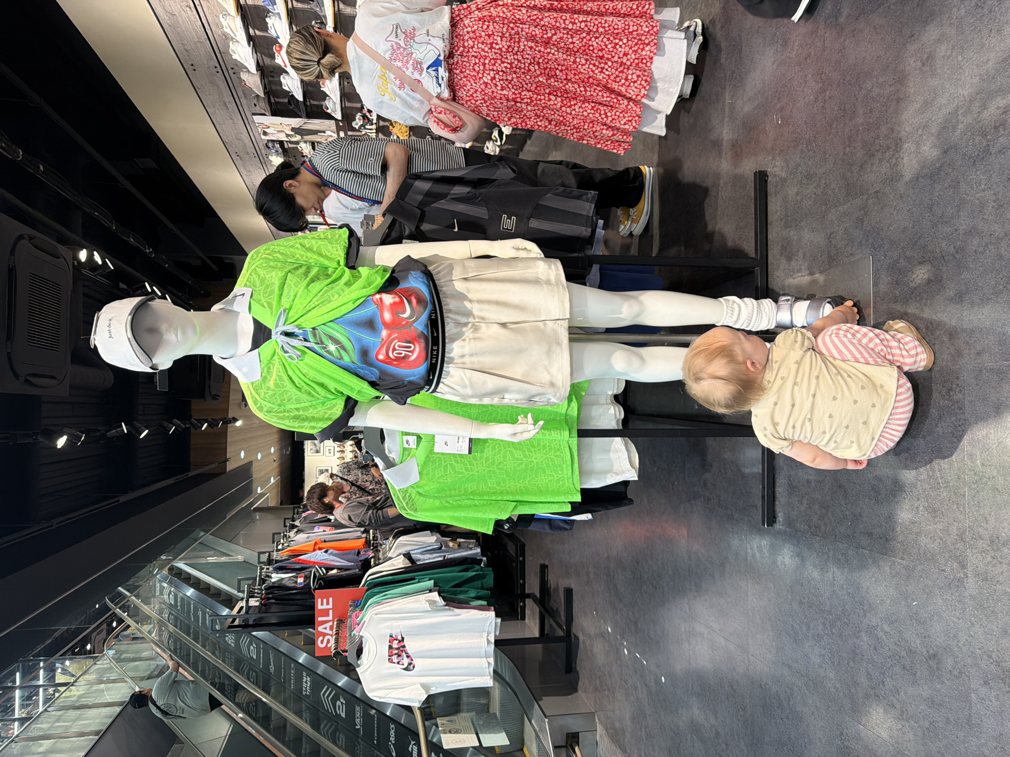 Weekend shoppers browse Kyoto arcade with children, pets, games