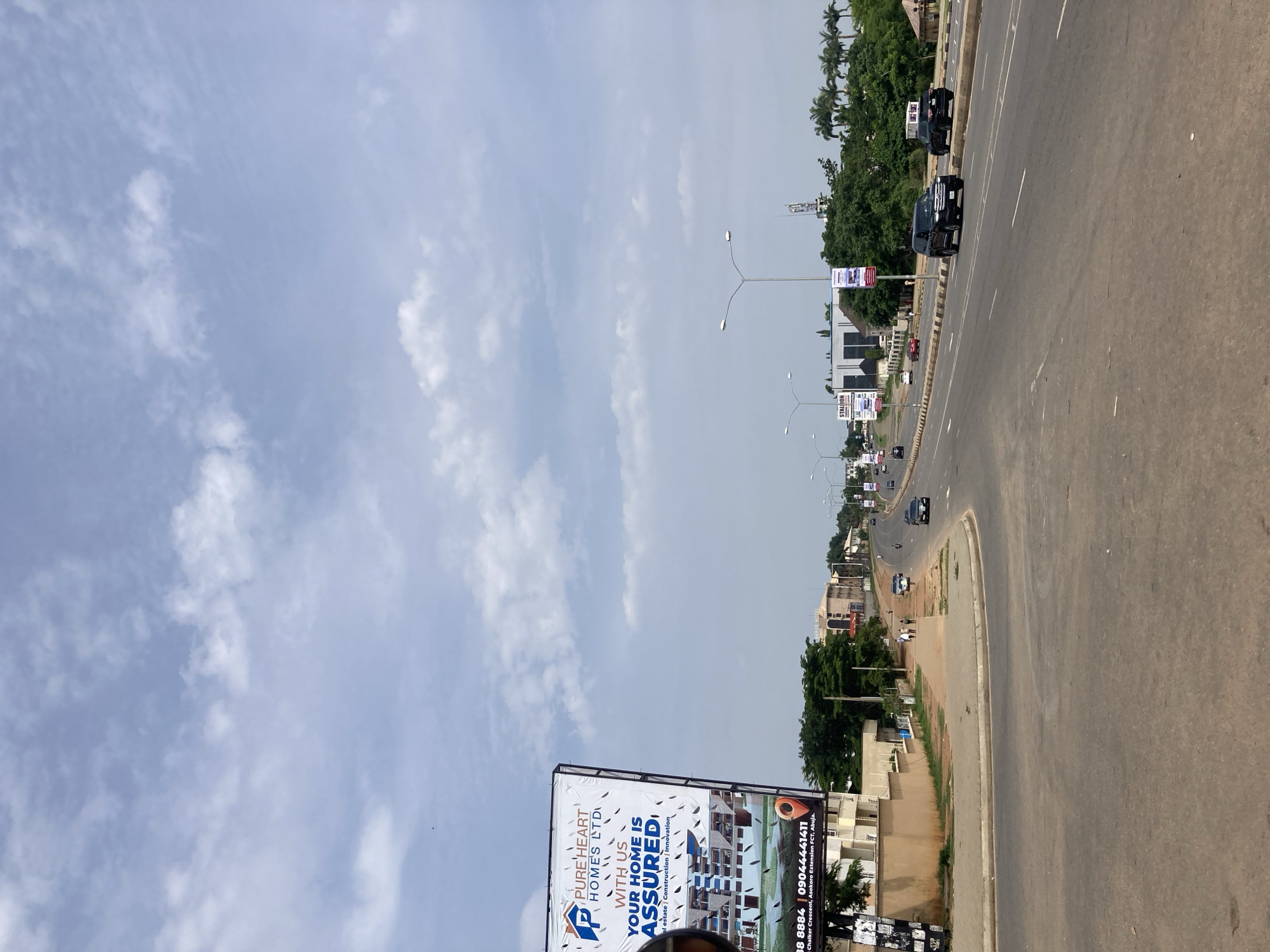 Morning traffic infrastructure observed in Abuja under partly cloudy skies