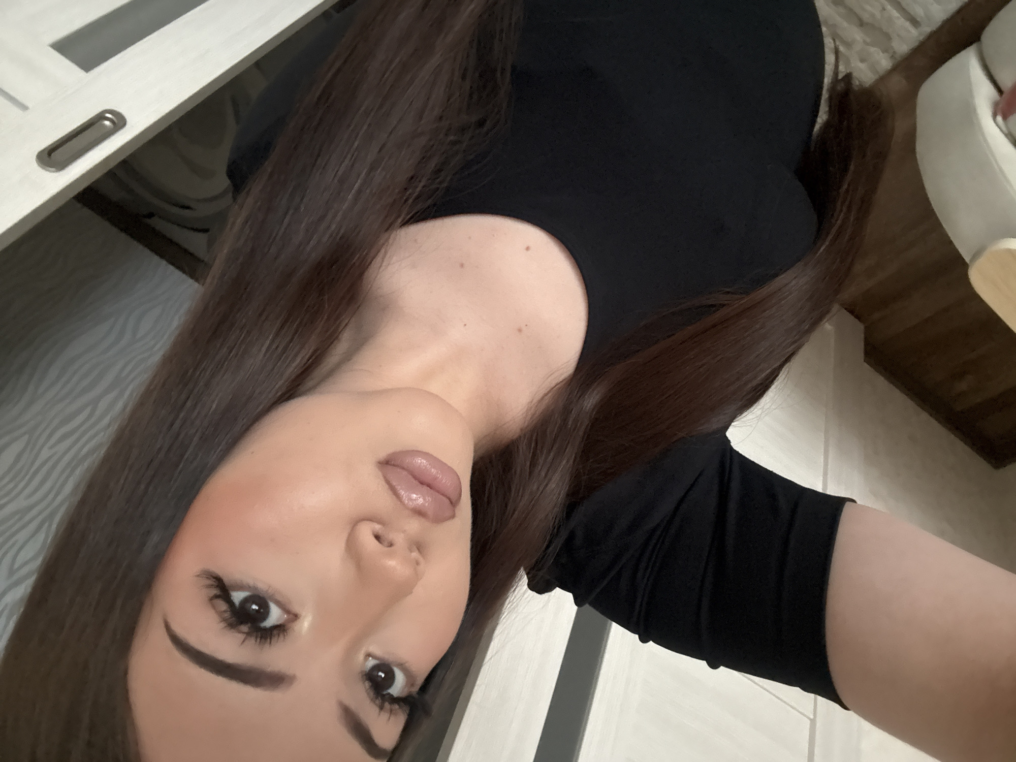 Woman photographs herself in residential setting in Naberezhnye Chelny