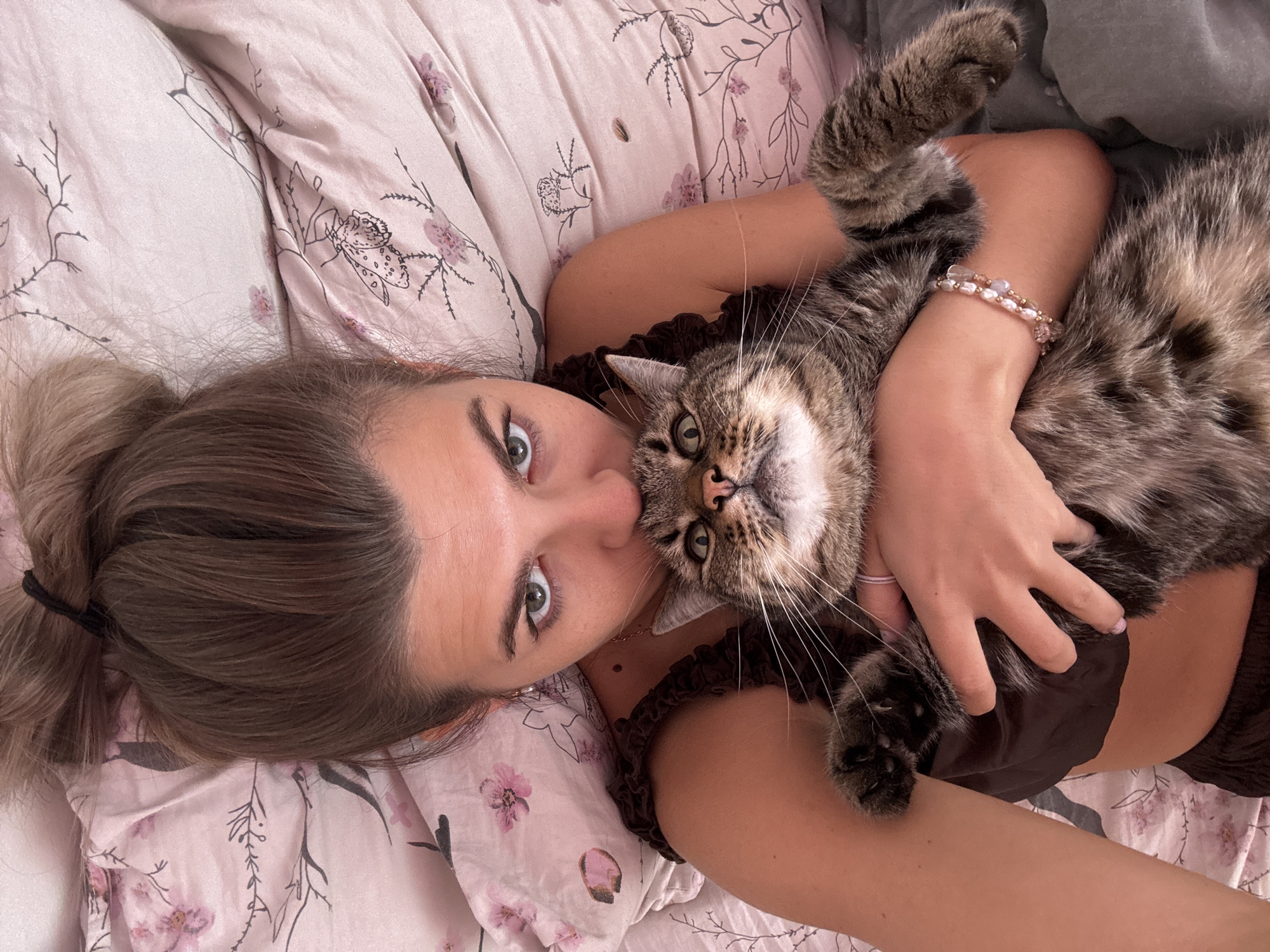 Morning cuddles with tabby cat in Chaikovsky bedroom