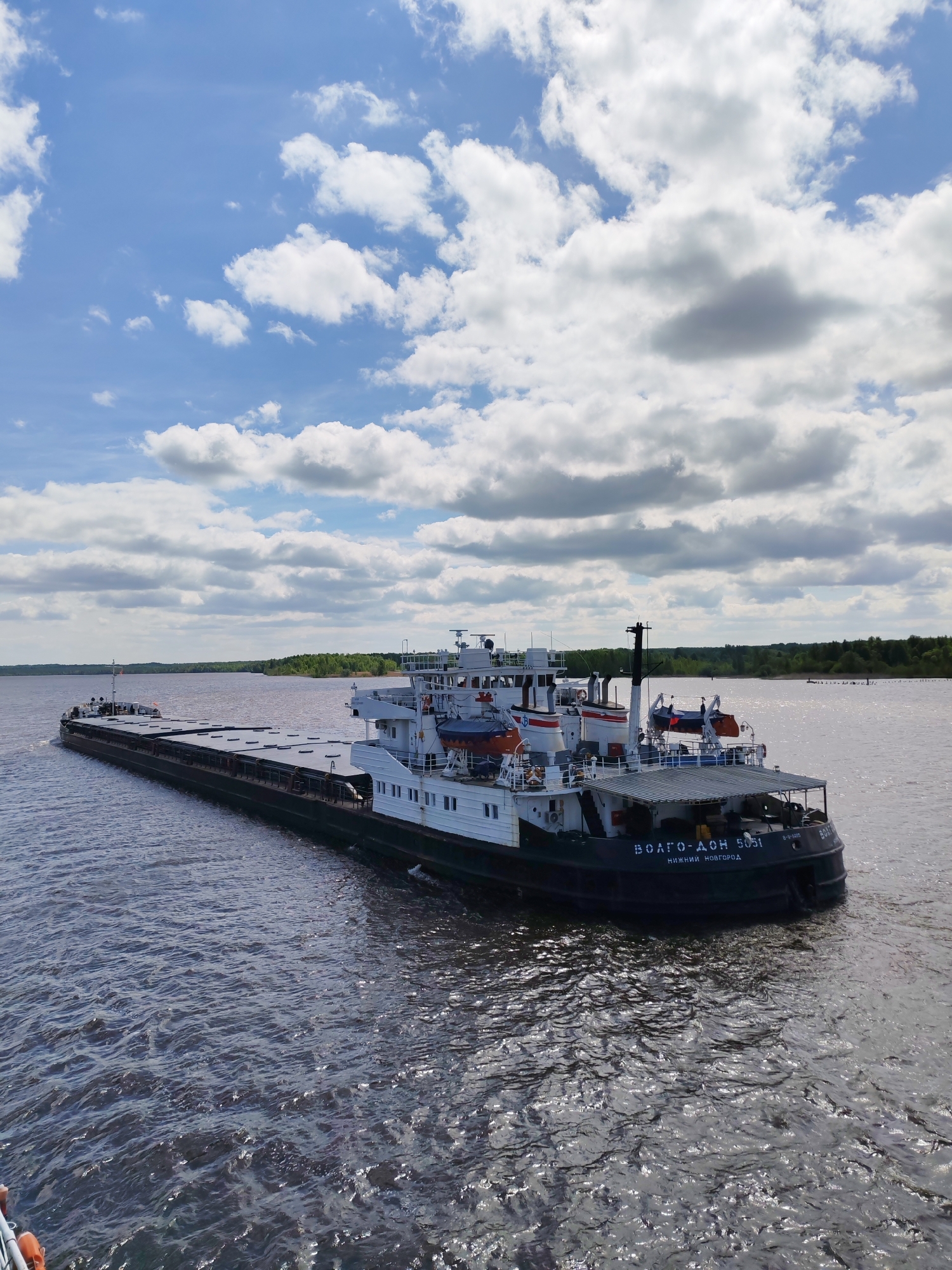 Barges transit Volga River near Popovo, Russia