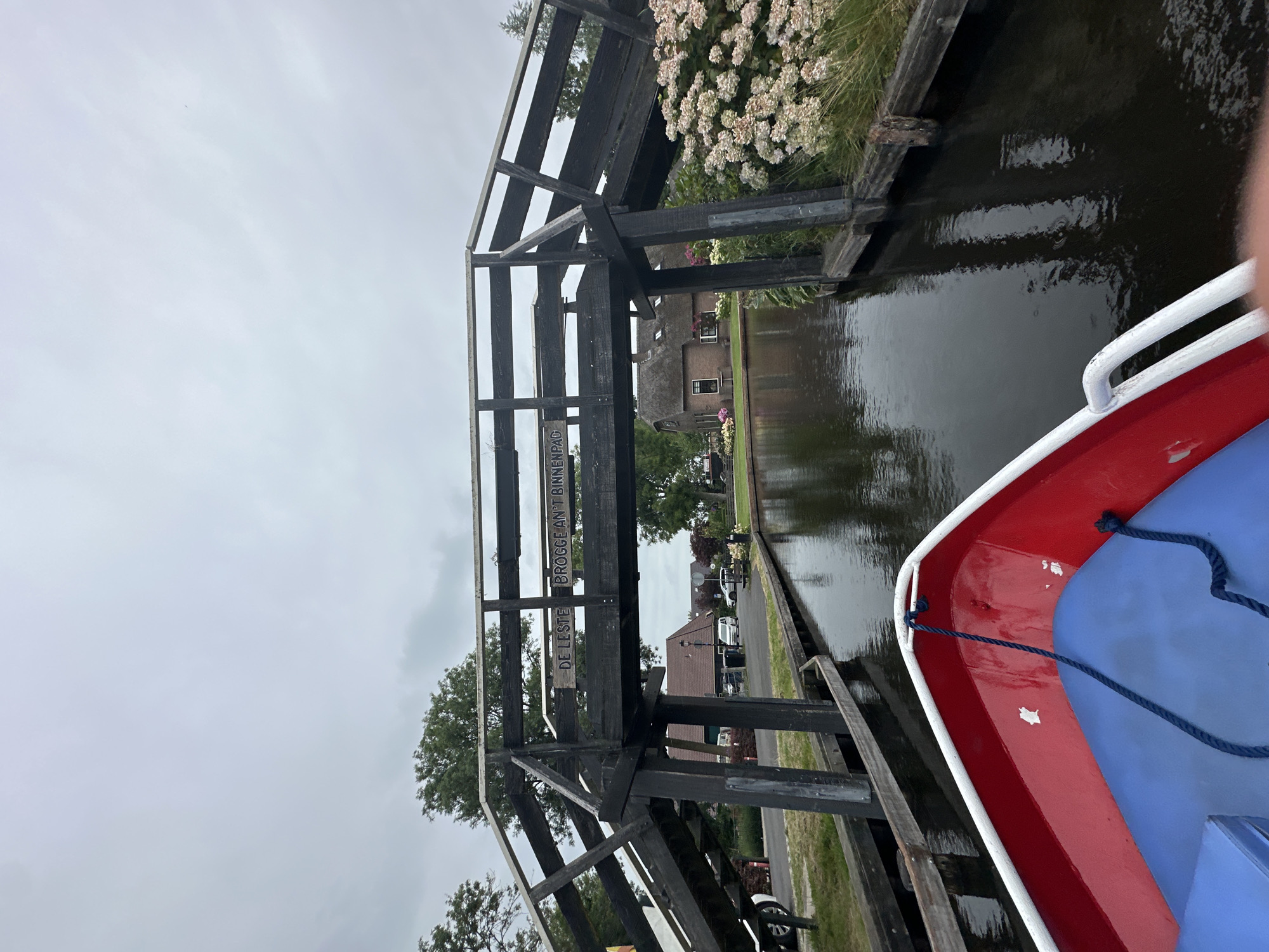 Boating through Giethoorn's canals on a grey summer morning
