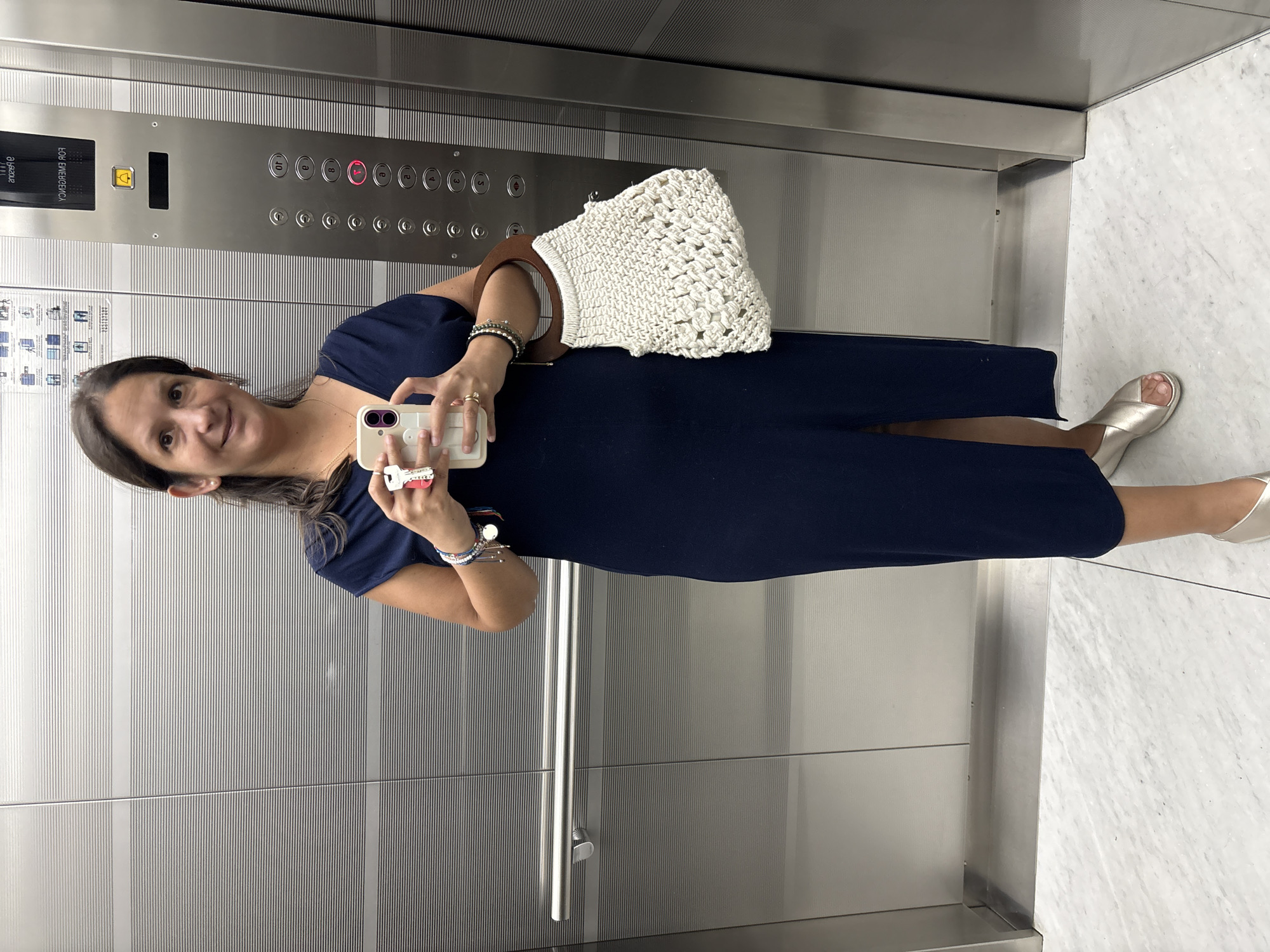 Woman takes phone photo in San Isidro elevator
