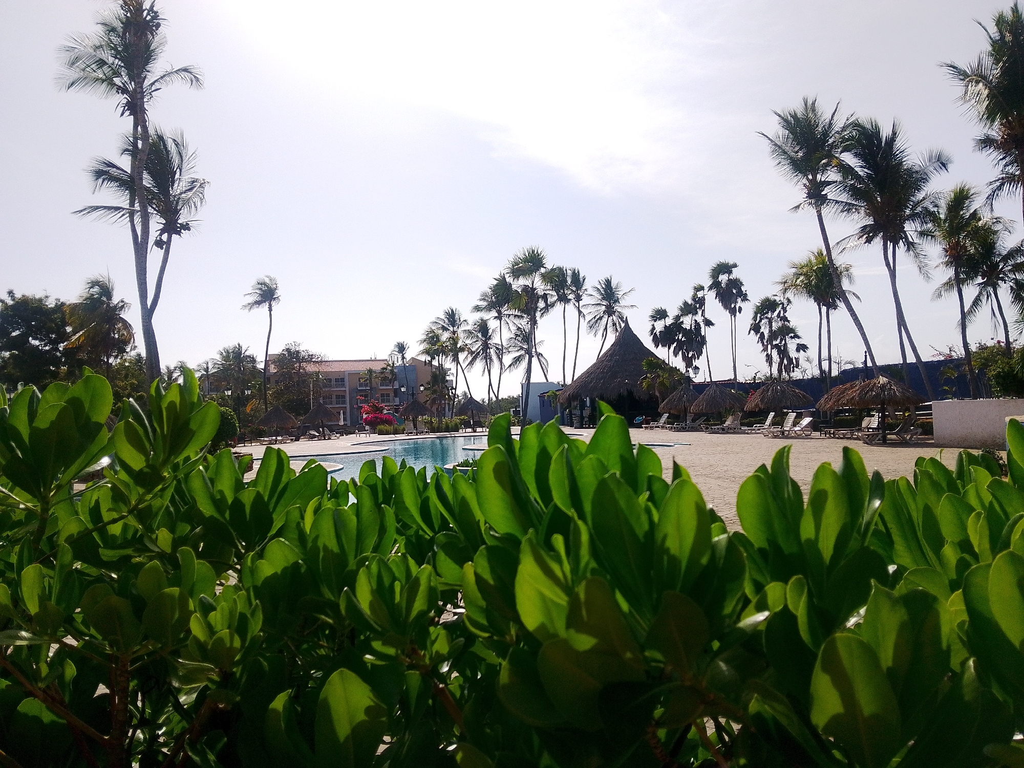 Tourist documents resort scenes at Playa El Agua, Venezuela