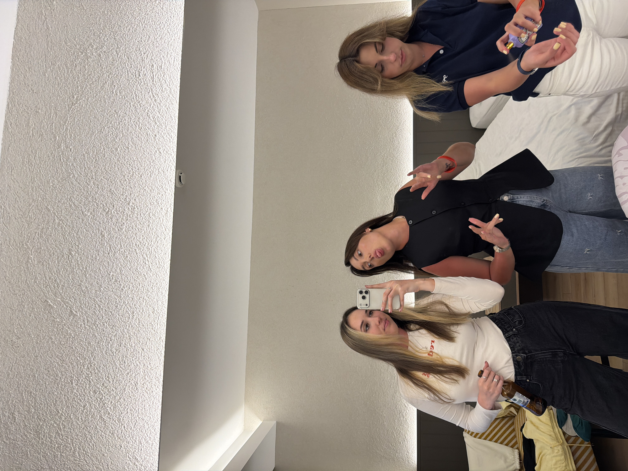 Young women take selfies in hotel room in Serik