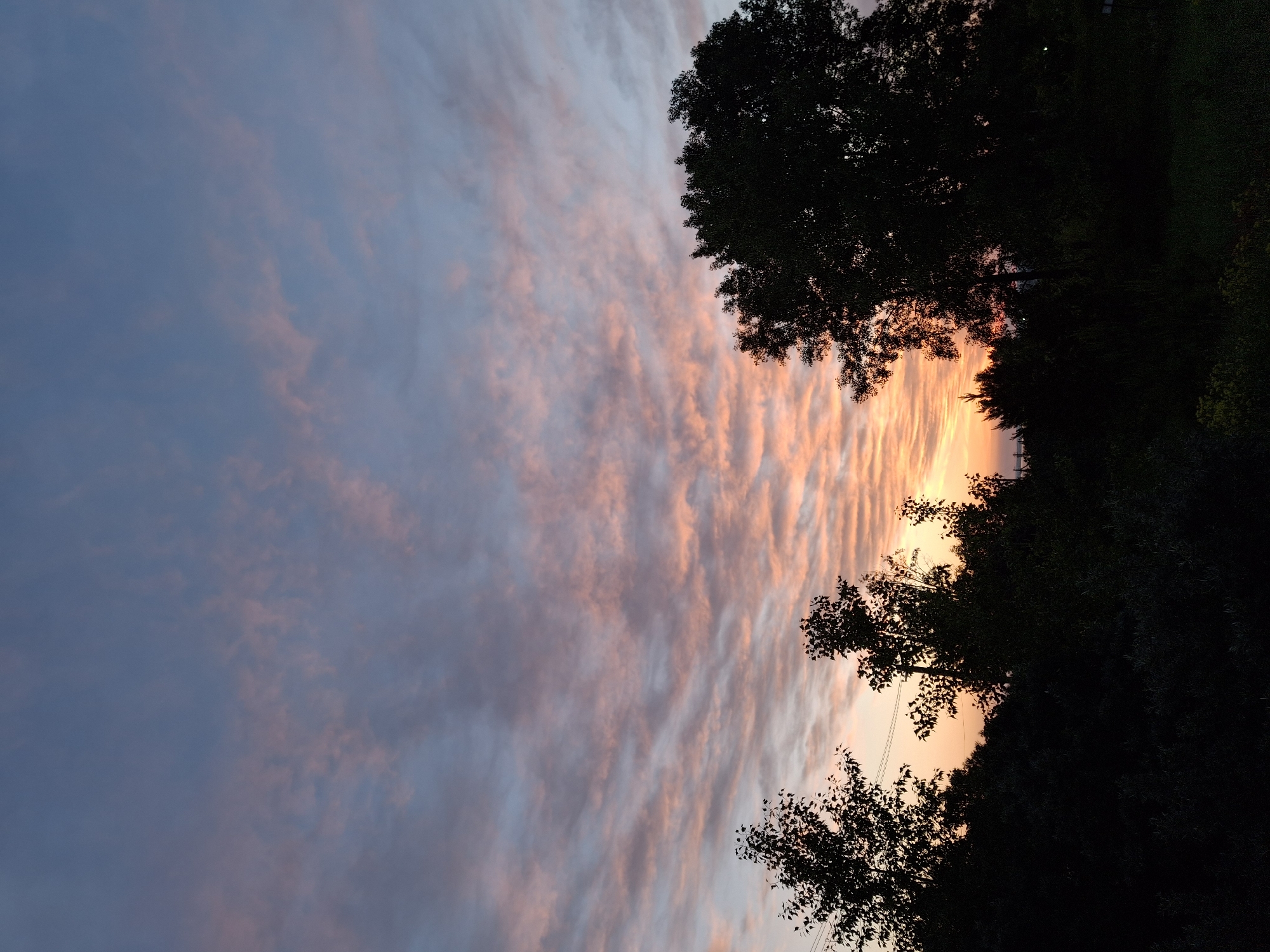 Vibrant sunset with rippling clouds observed over Chaikovsky, Russia