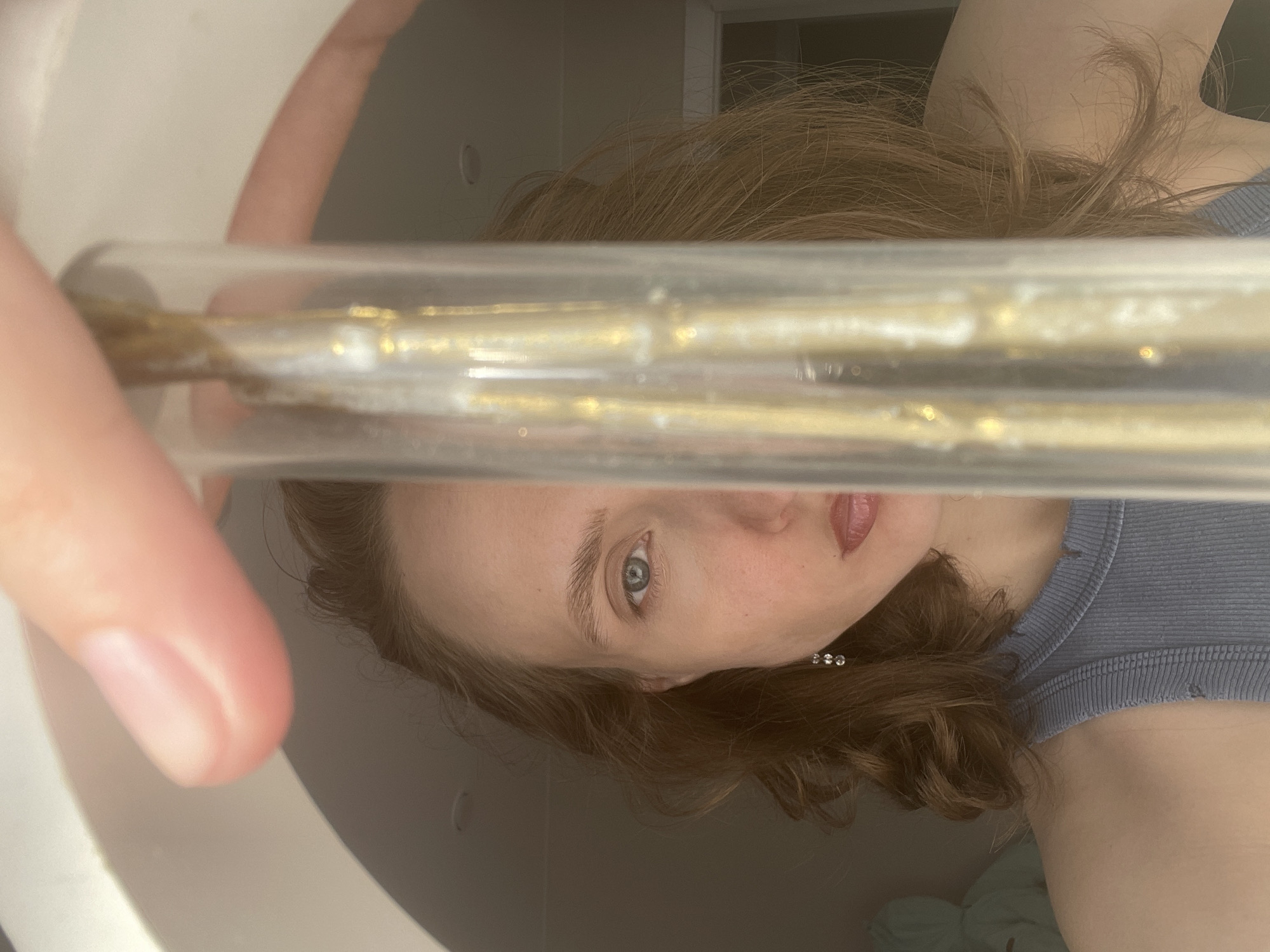 Woman Takes Selfies While Handling Golden Substance in Russian Home
