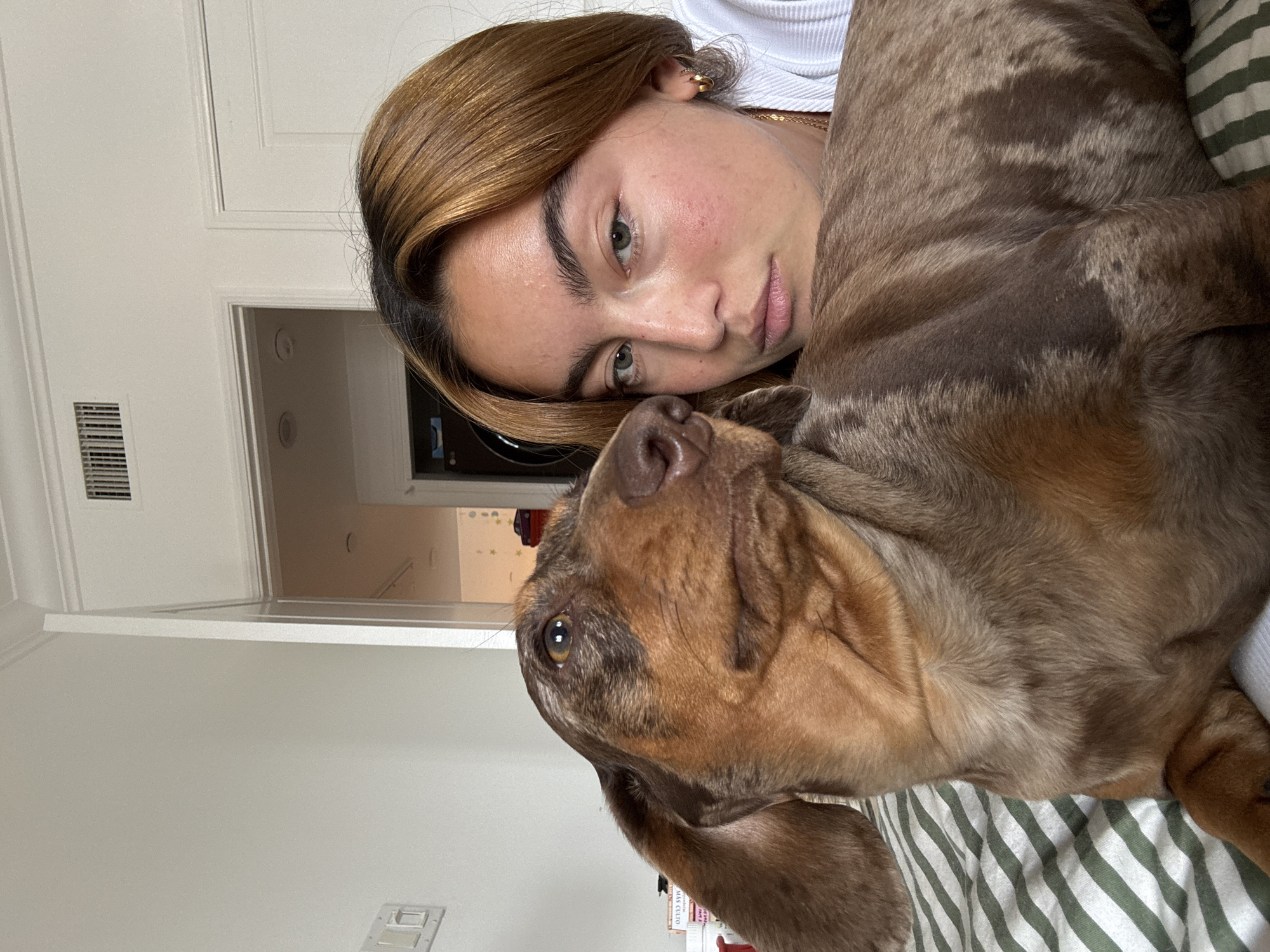 Woman and dachshund share quiet moments in Los Angeles bedroom