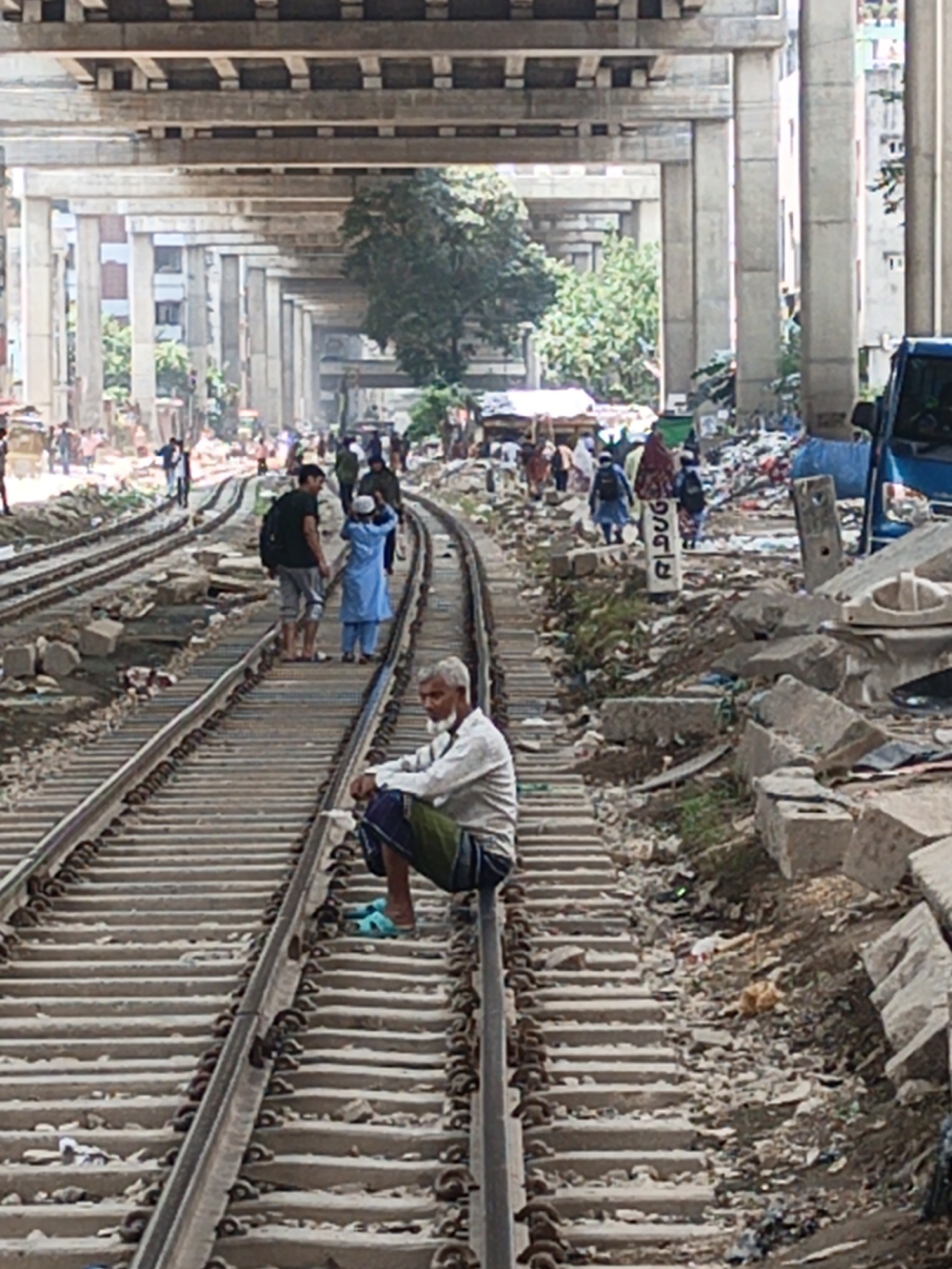 Daily life continues around Dhaka railway tracks, vendors active