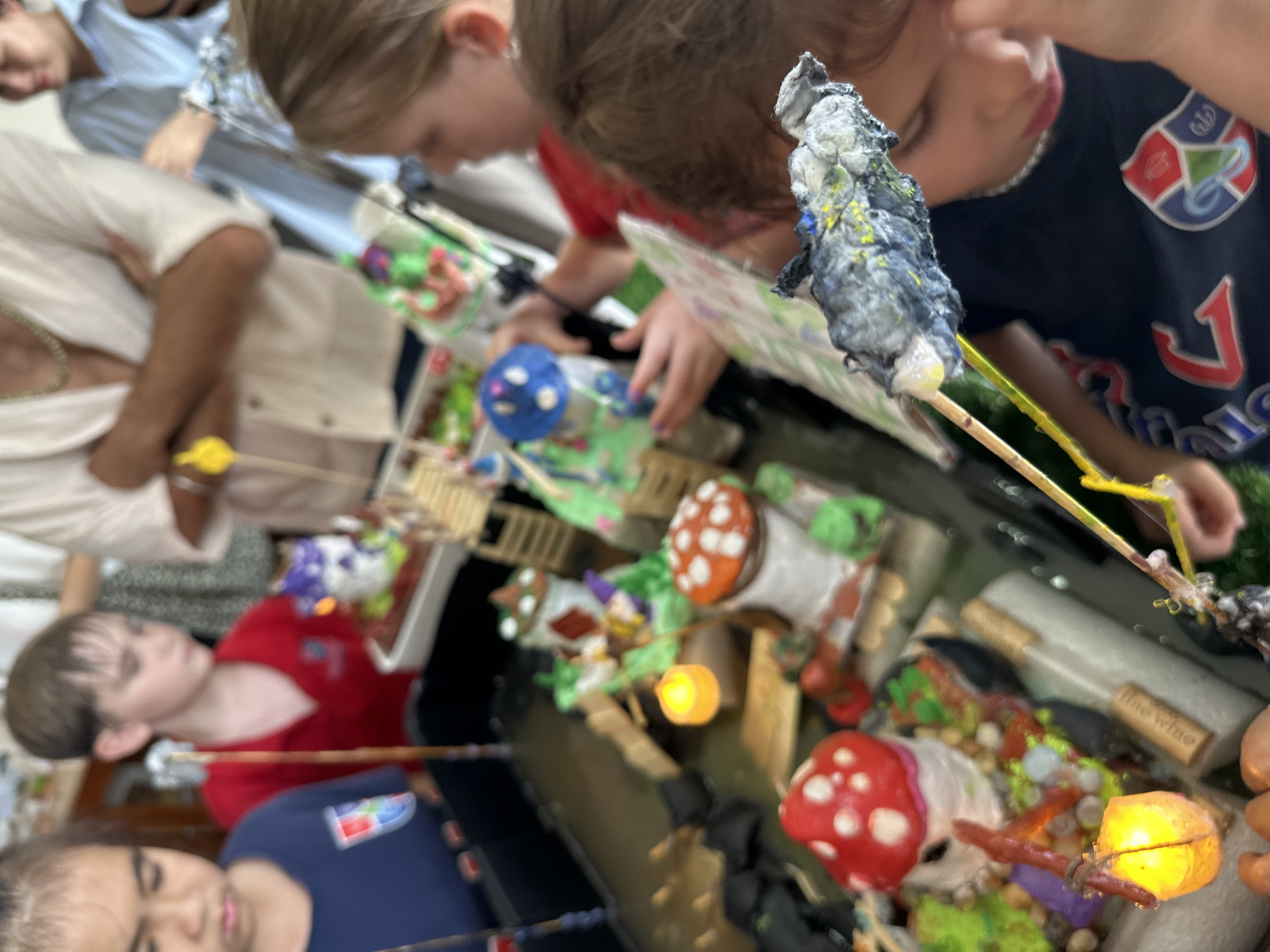 Kids showcase handmade gnome village dioramas at a Nha Trang school event